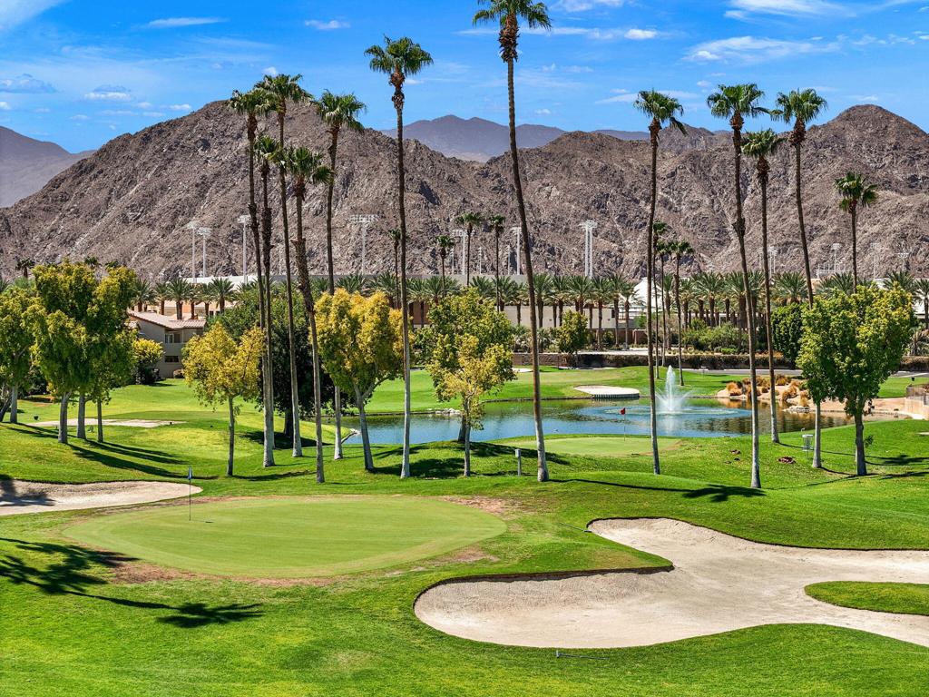 🎾 Just steps from the Indian Wells Tennis Garden, this condo offers more than just a home--it's a lifestyle. Enjoy dramatic fairway and mountain views from this golf course condo. The private patio features eastern exposure and an electric awning. This end unit model does not have a unit above and is light and bright. The kitchen features slab granite counters. Bath upgrades include custom tile enclosures and newer fixtures. Tile flooring in the main living areas. The bedrooms and closets feature raised panel doors. Energy efficient upgrades include Milgard vinyl windows and patio door, shutters and ceiling fans which combine luxury with sustainability. Decorated in warm neutral colors. Furnishings available. The inclusion of a 1-car oversize garage adds practicality to the package. The complex's amenities include 6 community pools and spa areas, to provide ample opportunities for relaxation and recreation. The added perk of UNLIMITED golf on a Ted Robinson designed par 3 course. Featuring tennis and pickleball courts that are well maintained. Now the area headquarters for Helix Disc Golf, enhances the lifestyle appeal. Low HOA dues covering essential services, cable, and internet make for worry-free living, while convenient access to shopping, dining, and transportation adds to the property's allure. Situated across from the Indian Wells Tennis Gardens, home of the Paribas Open, this property is perfect for either full-time residence or a luxury seasonal home. Overall, it truly offers a lifestyle of convenience and luxury, appealing to those seeking the ultimate in comfort and relaxation.