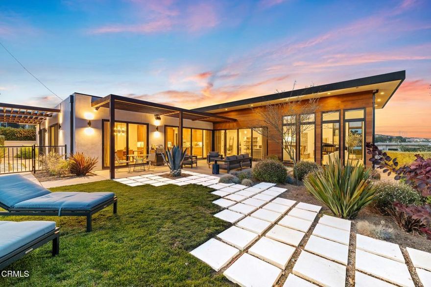 Experience elevated modern living in this architecturally refined home where every detail has been meticulously curated for comfort, style, and function. The heart of the home is a stunning kitchen featuring quartzite waterfall countertops, sleek custom cabinetry, and premium stainless steel Thermador appliances--all set atop wide plank white oak flooring that adds warmth and texture throughout.This gourmet kitchen flows effortlessly into a voluminous living room with soaring 11.5 -foot ceilings, framed by walls of glass that flood the space with natural light. A dramatic statement fireplace anchors the room, while panoramic ocean and city views serve as an ever-changing work of art.The luxurious primary suite offers a tranquil retreat, complete with its own sleek fireplace, a spacious spa-inspired bathroom, and a generous walk-in closet. Step out onto your private patio to soak in sweeping views and serene sunsets--an ideal space for morning coffee or quiet reflection.Outside, the home's exterior makes a bold impression with a sophisticated blend of natural cedar wood and smooth stucco. The beautifully landscaped yard offers room to relax or entertain, and includes a detached music studio--perfect for creative pursuits, a home office, or guest space.Every element of this home has been thoughtfully designed with high-end materials, abundant natural light, and seamless indoor-outdoor living, creating a rare blend of modern luxury and everyday comfort.