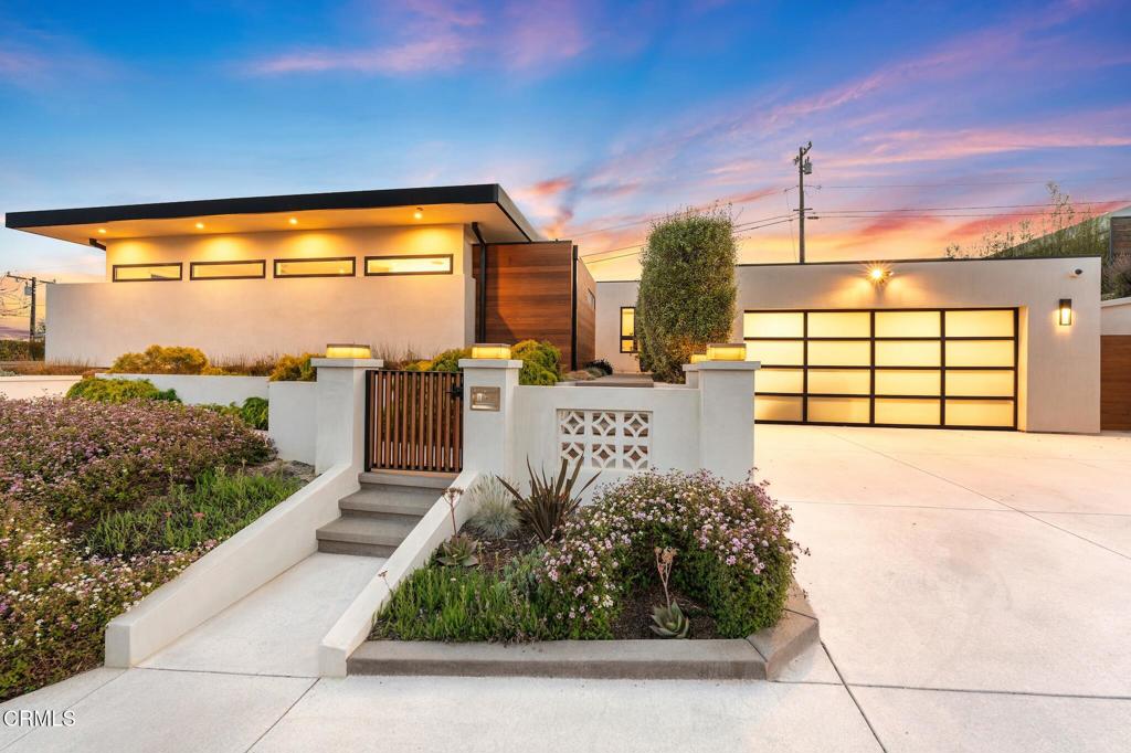 Experience elevated modern living in this architecturally refined home where every detail has been meticulously curated for comfort, style, and function. The heart of the home is a stunning kitchen featuring quartzite waterfall countertops, sleek custom cabinetry, and premium stainless steel Thermador appliances--all set atop wide plank white oak flooring that adds warmth and texture throughout.This gourmet kitchen flows effortlessly into a voluminous living room with soaring 11.5 -foot ceilings, framed by walls of glass that flood the space with natural light. A dramatic statement fireplace anchors the room, while panoramic ocean and city views serve as an ever-changing work of art.The luxurious primary suite offers a tranquil retreat, complete with its own sleek fireplace, a spacious spa-inspired bathroom, and a generous walk-in closet. Step out onto your private patio to soak in sweeping views and serene sunsets--an ideal space for morning coffee or quiet reflection.Outside, the home's exterior makes a bold impression with a sophisticated blend of natural cedar wood and smooth stucco. The beautifully landscaped yard offers room to relax or entertain, and includes a detached music studio--perfect for creative pursuits, a home office, or guest space.Every element of this home has been thoughtfully designed with high-end materials, abundant natural light, and seamless indoor-outdoor living, creating a rare blend of modern luxury and everyday comfort.