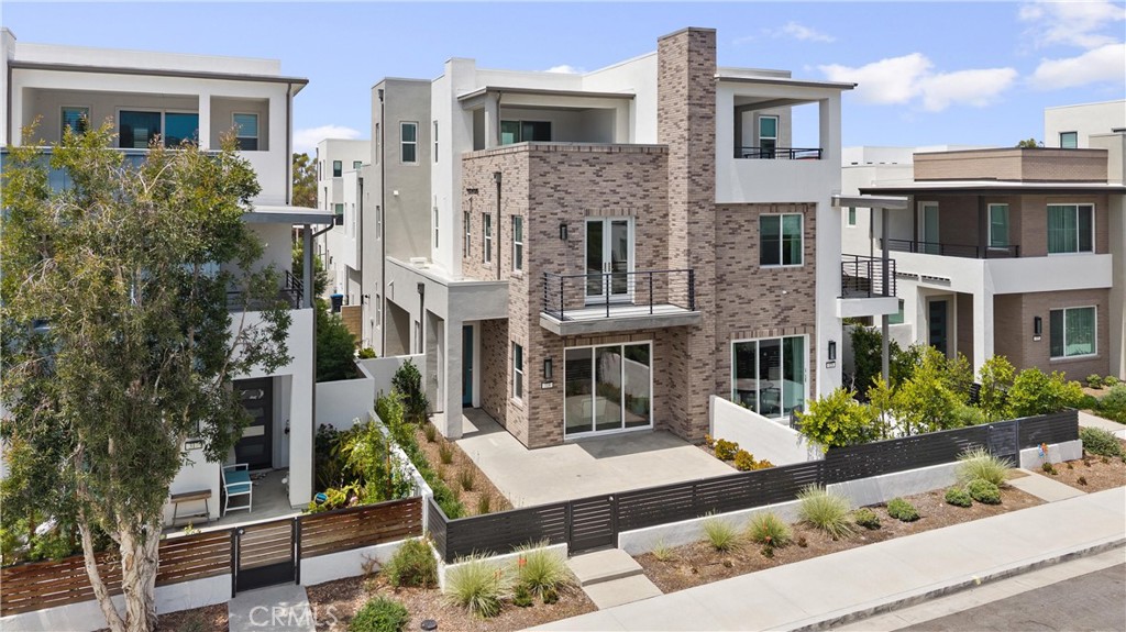 Nestled in the vibrant Novel Park neighborhood of Irvine’s highly sought-after Great Park community, 319 Novel offers modern comfort and thoughtful design across three spacious levels. Upon entering the welcoming first floor, you will find an open-concept layout seamlessly connecting the kitchen, dining, and living areas. The gourmet kitchen features sleek cabinetry, premium appliances, and a large center island that makes cooking and entertaining a breeze. Adjacent, the bright living area opens to an enclosed front porch, creating the perfect indoor-outdoor flow. A private side yard provides an additional space for relaxing or dining al fresco. On the second floor, you’ll find three generously sized bedrooms, including the serene primary suite with a en-suite bath and a walk-in closet. A second full bath and convenient laundry room complete this level, offering both functionality and comfort. The top floor opens to a versatile loft — perfect for a home office, playroom, or media room — with direct access to a private balcony where you can enjoy the fresh breeze and sunset views. As part of Novel Park, you’ll enjoy access to resort-style amenities including a clubhouse, pool and spa, BBQ areas, and sports courts, plus the convenience of top-rated Irvine schools and Great Park’s lively community atmosphere.