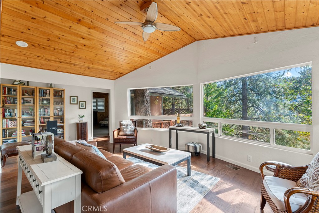 Mountain Retreat Near Lake Gregory. Discover this beautifully upgraded home, offering single level living and serene forest views. Nestled in a well-established area, this property blends comfort, style, and efficiency. Step into an inviting open layout where the kitchen, dining, and living spaces flow seamlessly together. The kitchen and bathrooms showcase granite countertops, warm wood and stone accents. Stainless steel appliances and a large island make the kitchen a cook’s dream. Interior shutters add a touch of timeless elegance. Ample storage is found throughout, including Closet World cabinetry in the primary closet and garage. Downstairs, a versatile bonus area is ready to become your music studio, home gym, or hobby workshop. Prepared for any season, the home features a Generac standby generator, dual-pane windows, a tankless water heater, and a one-year-old Class A fire-resistant roof. The large fireplace has an insert ideal for taking the chill off those winter nights while a Samsung air conditioning unit keeps the office cool and comfortable year-round. Enjoy true mountain living with a spacious deck, stone patio, and fenced yard bordered by charming stone walls. The garage offers epoxy flooring and ample parking, and the front patio includes a gas connection ready for your BBQ gatherings. A home filled with good vibes, thoughtful improvements, and the kind of neighborhood where people still wave hello, this is mountain living at its best.