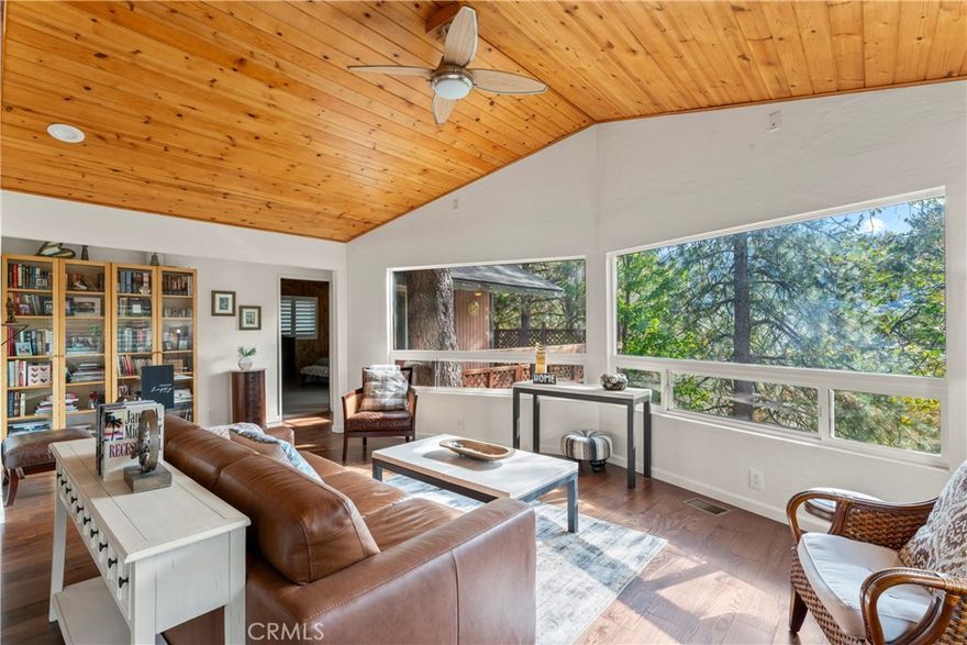 Mountain Retreat Near Lake Gregory. Discover this beautifully upgraded home, offering single level living and serene forest views. Nestled in a well-established area, this property blends comfort, style, and efficiency. Step into an inviting open layout where the kitchen, dining, and living spaces flow seamlessly together. The kitchen and bathrooms showcase granite countertops, warm wood and stone accents. Stainless steel appliances and a large island make the kitchen a cook’s dream. Interior shutters add a touch of timeless elegance. Ample storage is found throughout, including Closet World cabinetry in the primary closet and garage. Downstairs, a versatile bonus area is ready to become your music studio, home gym, or hobby workshop. Prepared for any season, the home features a Generac standby generator, dual-pane windows, a tankless water heater, and a one-year-old Class A fire-resistant roof. The large fireplace has an insert ideal for taking the chill off those winter nights while a Samsung air conditioning unit keeps the office cool and comfortable year-round. Enjoy true mountain living with a spacious deck, stone patio, and fenced yard bordered by charming stone walls. The garage offers epoxy flooring and ample parking, and the front patio includes a gas connection ready for your BBQ gatherings. A home filled with good vibes, thoughtful improvements, and the kind of neighborhood where people still wave hello, this is mountain living at its best.