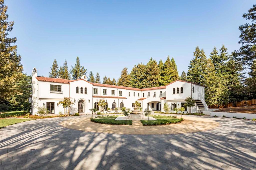 Tucked away on over 1.5 acres in exclusive Atherton, this grand estate offers the ultimate in luxury and privacy while providing an unmatched living experience. Recently completed, this home offers 7 bedrooms, 8 bathrooms, 2 half baths, and over 11,000 square feet of living space, including a beautiful guest home. Top-of-the-line materials including marble countertops, porcelain and terracotta tiles, European white oak floors, and solid wood doors and beams. Elegant gathering spaces make this an entertainer's dream, with multiple rooms opening to the resort-like grounds featuring a brilliant pool. Luxurious highlights include four fireplaces, a spectacular gourmet kitchen plus an additional full kitchen upstairs, a study, and a high-end theater. Find sanctuary in the palatial master suite and enjoy four additional bedroom suites perfect for hosting family and guests.