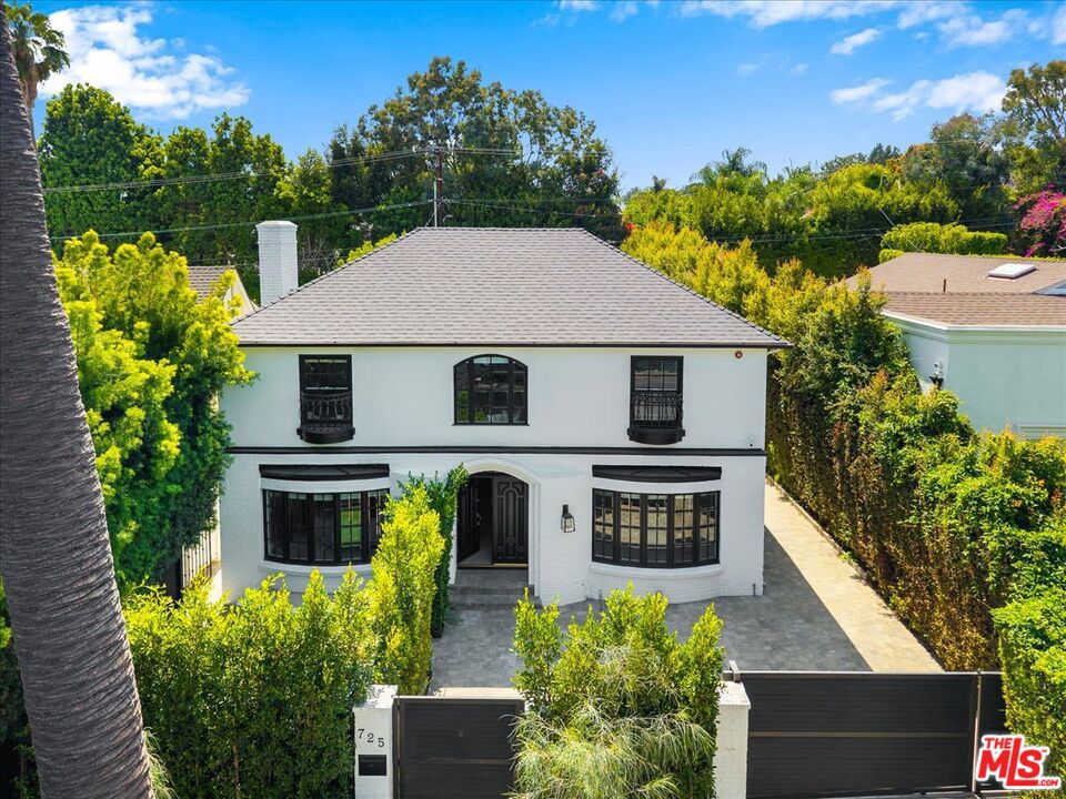 Experience the epitome of refined California living at 725 North Doheny, a fully gated and exquisitely renovated private compound located in one of Beverly Hills' most sought-after neighborhoods. This rare two-story residence blends timeless elegance with modern luxury, offering a seamless balance of style, comfort, and sophistication. Beyond the gates, a spacious motor court and mature, manicured landscaping create a grand sense of arrival. Inside, the home features four generously appointed bedrooms and four designer bathrooms, all finished with the highest level of craftsmanship and detail. Warm wide-plank wood floors, custom millwork, and multiple fireplaces infuse the interiors with character and charm, while the chef's kitchen connects effortlessly with both formal and casual living spaces perfect for intimate evenings or grand-scale entertaining. Step outside to a true resort-style oasis. A sparkling pool and spa are surrounded by thoughtfully designed outdoor areas ideal for lounging, dining, or entertaining under the California sun. A detached guest house with a full bathroom offers ultimate flexibility perfect as a guest suite, gym, office, or creative studio.With alley access, exceptional privacy, and close proximity to world-class shopping, dining, and entertainment, this turnkey residence offers an unparalleled lifestyle opportunity in the heart of Beverly Hills.