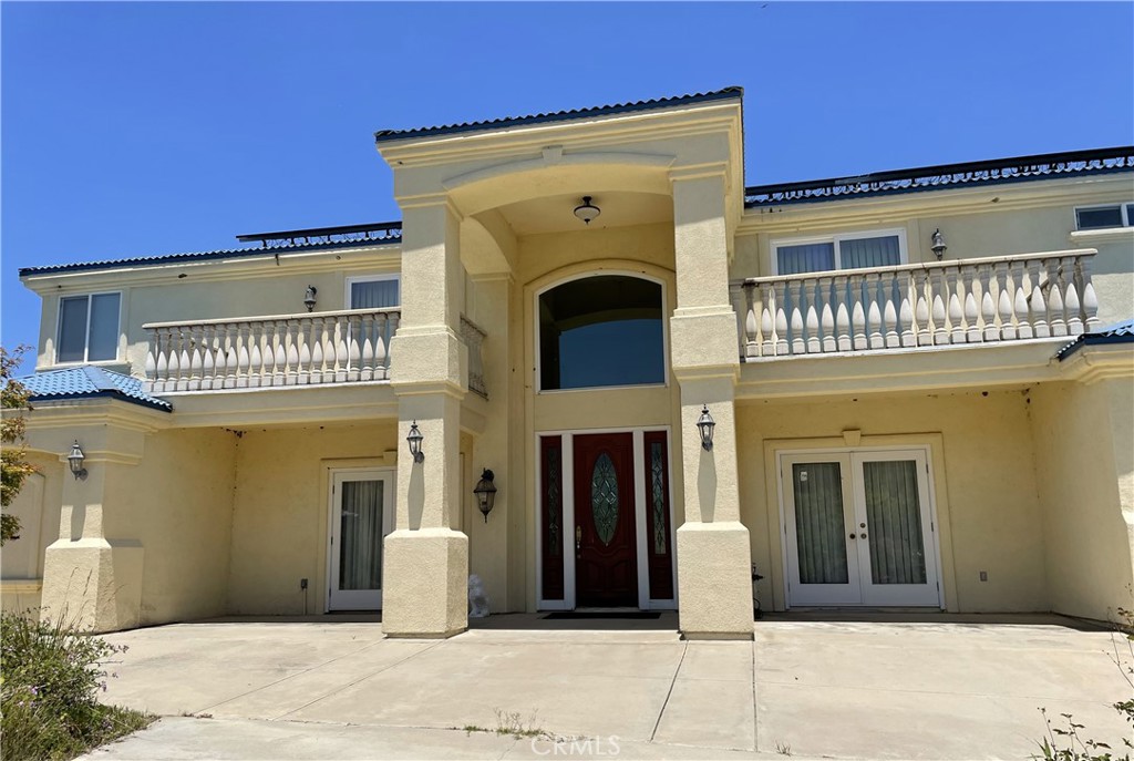 This exceptional 9.48-acre estate ensures privacy and luxury, featuring a 6,223 sq ft main home and a never-occupied, 890 sq ft guest house. The main residence is crafted for durability and accessibility with 6-inch exterior walls, a steel roof, 36-inch doorways, and a fully paid 120KW solar system. Inside, the open layout boasts granite floors, 18-foot ceilings, a grand family room, chef’s kitchen, dual marble fireplaces, a huge pantry, office, and a lavish master suite. Spacious upstairs bedrooms each have private balconies and full baths. The elevator serves all three levels, including a four-car garage and a game room. The guest house, with steel and 8-inch walls, includes two bedrooms, one bath, new appliances, bamboo floors, solar water, a three-car garage, laundry, and an additional exterior-access bathroom for workers. Additional (3) Contiguous (3) Parcels for Sale as well, All parcels are certified organic avocado grove, water supplied by Rancho California Water District and each has its own 11/2” water meter. Buy all (4) parcels as a 36+/- acre bulk sale. Seller will consider short term financing to well qualified Buyers. No Homeowner's Association.