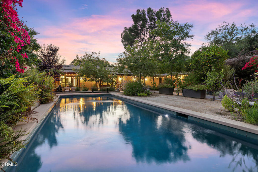 Welcome to this quiet family compound, tucked away on the East End of Ojai. Offering a place for everyone, with a combined square footage of 4965, which includes 6 bedrooms, 4.5 bathrooms. Originally built and designed by Mr. Shippee for his family. As you enter through the gate of the main house you are welcomed by a private courtyard, covered veranda, sparkling pool, impressive landscaping, and undeniable charm. Thoughtfully remodeled with elegant acacia wood floors, this home features an open kitchen, seamlessly connected to the dining room, highlighted by a stunning double-sided fireplace. Designed for both comfort and style, it's truly an entertainer's dream. A cook's kitchen with top of the line appliances, plenty of counter space and light. Offering three bedrooms with French doors opening to the gardens, two and a half bathrooms. The guest house offers nearly 1400 square feet, has two bedrooms and one bathroom, a lovely private courtyard with a patio and a double car garage, making It perfect for guests and extended family. The rear house showcases modern concrete floors, 1 bedroom, 1 bath, a spacious living room, kitchenette, and two secluded patios for outdoor living. Well-designed grounds showcase a blend of drought tolerant landscaping and abundant fruit trees, including apple, orange, lemon, fig, pomegranate, and stately olive trees that gracefully line the driveway. Horse-friendly property with fenced paddock and turnout area. Altogether, this property offers three private homes, with a perfect mix of indoor/outdoor living, making it a truly unique property that combines functionality, versatility, and timeless charm.