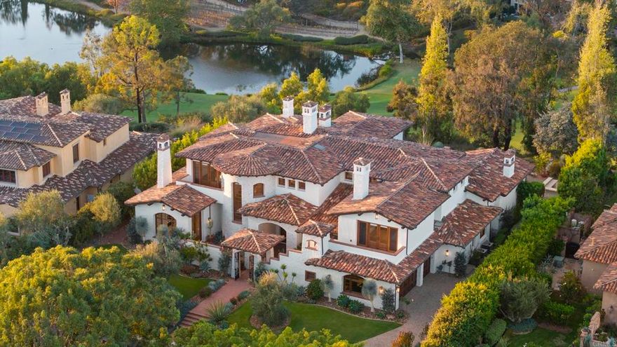 This stunning 5+ bedroom modern European estate offers an expansive view that overlooks the 9th Fairway and iconic clubhouse within the prestigious guard-gated community of The Bridges in Rancho Santa Fe. Extensively remodeled, completed in 2025, the 8,900+sqft residence captures the essence of refined living with a seamless blend of craftsmanship, comfort, and design—all framed by one of the community’s most sought-after views.   Inside, natural light pours through expansive windows and French doors that open to the golf course, creating a perfect indoor/outdoor connection ideal for both daily living and entertaining. Every finish was chosen with care—from hand-finished limewashed fireplaces and European white-oak floors to Italian marble countertops, burnished-brass fixtures, and designer lighting. The reimagined kitchen serves as the heart of the home with a farmhouse-style sink, premium appliances, oversized walk-in pantry, bar, and temperature-controlled wine cellar that make entertaining effortless. Additional spaces include a built-out home theater, elegant office, and a separate guest wing with private access that offers versatility for guests, multigenerational living, or creative use.  The primary suite is a true retreat, featuring a newly remodeled bathroom in Italian marble with dual vanities, a freestanding soaking tub, and spa-like tranquility. Outside, the lush grounds create a resort-like backdrop for year-round living with a saltwater pool and spa, built-in BBQ bar, and sweeping fairway views framed by golden evening light over the clubhouse.  Set within one of Rancho Santa Fe’s most desirable golf communities, residents of The Bridges enjoy world-class amenities, fine dining, and 24-hour security—all just minutes from Rancho Santa Fe Village, top-rated schools, and the coastal towns of Del Mar, Solana Beach and Encinitas.