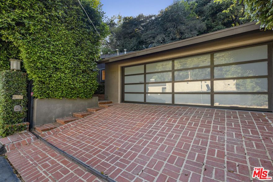 Just minutes from Sunset Blvd, this fully gated, single-story 3 bed/2 bath cozy home offers exceptional privacy and style. The tranquil yard features lush landscaping, a beautiful fountain, and multiple outdoor seating areas, creating a seamless indoor-outdoor lifestyle. The living room centers around a grand fireplace and flows seamlessly into a formal dining area. The updated kitchen includes modern amenities and a cozy breakfast nook. One guest bedroom is perfectly suited for visitors or a home office, while another bedroom and the primary suite open onto a spacious side yard through French doors. The primary suite also features an ensuite bath and a serene ambiance. Set on a sprawling half-acre lot, the property provides ample space for expansion or future development, offering flexibility to enhance and personalize the home. Enjoy the feeling of being on a retreat every day, with easy access to The Glen Centre and the Golden Triangle of Beverly Hills.