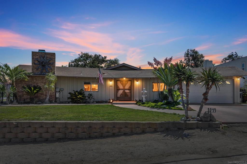 This four-bedroom, two-and-a-half-bath custom home, built in 1963, offers 1,986 sq. ft. on a 0.31-acre lot atop a hill in Escondido, providing privacy and sweeping views. Enjoy breathtaking sunrises, colorful evening skies, and even front-row seats to Fourth of July fireworks. The property is surrounded by mature landscaping and an abundant orchard with lemon, lime, orange, tangerine, peach, apricot, apple, cherry, plum, olive, and banana trees truly one of a kind. Inside, soaring ceilings and an open layout create a bright, inviting atmosphere. Lovingly maintained, the home is filled with warmth and opportunity for your personal touch. Energy-efficient solar adds peace of mind, while thoughtfully designed grounds expand lifestyle possibilities. The terraced yard includes multiple entertaining areas, a garden, and a chicken coop for fresh eggs and farm-to-table living. With room to relax, host, or create a private retreat, the property also offers potential for an ADU, shed, or additional sanctuary. Ample parking includes space for an RV or boat plus a convenient RV cleanout. With no HOA, you’ll enjoy the freedom to live your way. Conveniently close to shopping, dining, transit, the Sprinter, and freeway access to the 15 and 163, this Escondido gem blends charm, sustainability, and opportunity—all with skies and views you’ll never want to leave.