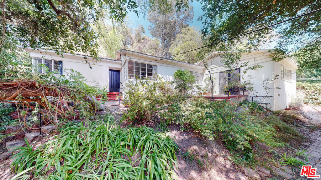 Nestled beneath a lush canopy of mature trees in the picturesque Beverly Glen Canyon of Bel Air, this refreshed 4-bedroom + den, 3-bathroom retreat offers the perfect blend of privacy, charm, and convenience. Located on a peaceful lane just minutes from both the Westside and the Valley, this hidden gem offers the best of both worlds. Step up from the street or detached garage into a charming entryway that sets the tone for the tranquility that lies within. The primary bedroom features a versatile adjoining denperfect for a home office or reading nookplus a walk-through closet and a private vanity area that connects to the ensuite bath. The oversized living and dining room is bathed in natural light, creating an inviting space for gatherings or quiet evenings at home. Down the hall, you'll find a full bathroom, laundry closet, and two additional bedrooms, each offering comfort and style. Just beyond the dining area, the practical kitchen includes a pantry and opens to a third bathroom and fourth bedroomideal for guests or extended family. Most rooms seamlessly flow to a serene, private rear yard, perfect for al fresco dining or morning coffee under the trees. While the fireplace can add charm and character, it was sealed off over 15 years ago and no credits will be given for repairs, if needed. The Seller considers the fireplace as decorative only. This is a rare opportunity to own a slice of canyon paradise in one of Bel Air's most sought-after enclaves.