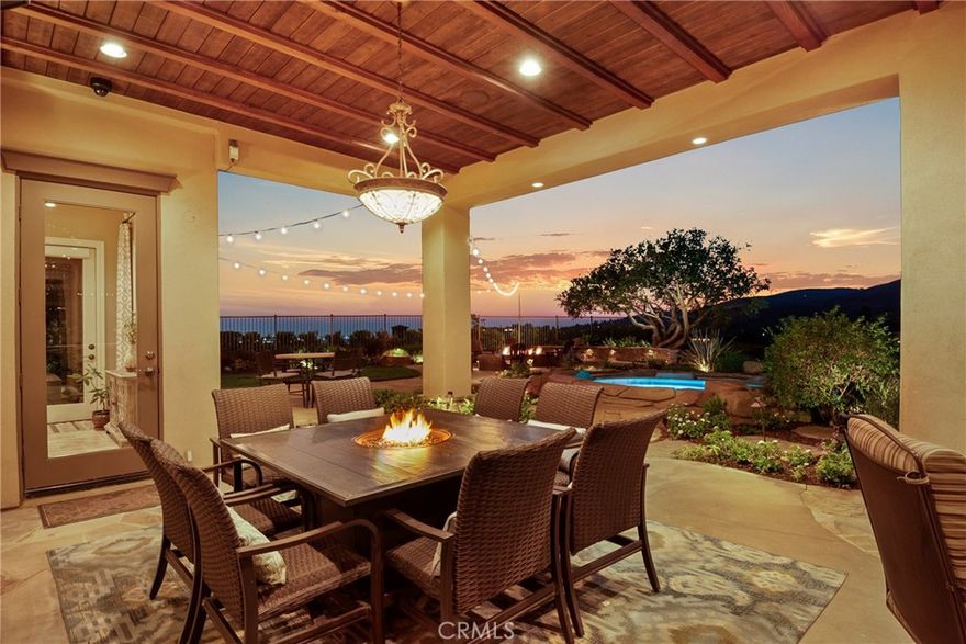Welcome to this luxury estate in the highly sought after Mt. San Antonio neighborhood of Yorba Linda, situated on private streets with approved plans for a gated entrance to ensure even more privacy and security. Available for the first time on the market, this Plan 5 former model home is the largest floorplan offered & sits on one of the best lots in the community, a 1.06-acre private cul-de-sac property with ADU and RV potential, zoned for horses, & surrounded by a beautiful neighborhood of horse trails, hiking, & biking paths that back up to Chino Hills National Forest. The home spans 5,734 sq ft & offers 5 spacious en-suite bedrooms and 6 baths. Inside, you’ll find beautiful flooring throughout & professional designer finishes. The double door entry with custom beveled glass opens to an entertainer’s dream floor plan with 2 staircases & multiple living & entertaining spaces. The chef’s kitchen boasts a large island with seating and a prep sink, top of the line appliances including Sub Zero, Thermador, Bosch, and U-line, plus a walk-in pantry. The home also features a custom full bar with seating for six, a leathered quartzite bar top, wine & beverage refrigerator, Scotsman cocktail ice maker, cigar humidor, & a copper sink, with La Cantina bi-fold doors opening to the expansive patio. Additional highlights include a 4-car garage with epoxy floors, an upstairs bonus room with a large deck and fireplace, a hidden A/V room under the stairs, & a fully integrated Control4 whole-house automation system managing lights, HVAC, music, TVs, alarm, cameras, pool equipment, & Lutron window shades. Speakers throughout the home, garage, patios, BBQ area, putting green, and pool areas ensure seamless indoor-outdoor living. The backyard is a private resort like retreat, complete with an infinity edge rock pool featuring a water slide, grotto with jets, waterfalls, water features, & spa, as well as two lava rock firepits, 5 fireplaces total throughout the property & endless spaces to gather & entertain. Outdoor amenities include a kitchen and BBQ area with Viking appliances, a 2 tap kegerator, a 6-hole putting green with 2 sand traps & a chipping green, mature oak trees, fruit trees (lemon, orange, tangelo, lime, peach, plum and avocados), plus two garden boxes ready for spring planting. Stunning Catalina, Disneyland fireworks, & sunset views. With beautiful curb appeal, this home embodies luxury, privacy, and lifestyle. This is truly a dream property and a rare find.