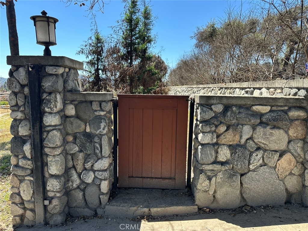 FINANCING AVAILABLE! Set in one of Altadena’s most desirable enclaves, with 23,962 sq ft of FLAT RECTANGULAR 100% USABLE land which had TWO HOUSES ON A LOT, this is the LARGEST flat usable piece of land for sale in Altadena under $1M! PHASE 1 & 2 COMPLETE! Privately set behind an impressive 90’ river rock wall with gated entry, this property features a long paved driveway for separate entrances, established utility connections to sewer, electric and natural gas and the flexibility for a variety of development strategies. Previously, there was a 2,185 sq ft craftsman main house which was featured in House & Garden in 1907 plus a 930 sq ft guest house. With zoning and previously approved permits for two on a lot, bring your vision to life - whether it’s a primary residence and a legally permitted Accessory Dwelling Unit (ADU), guest house, or second home—perfect for multigenerational living or rental income. Enjoy easy access to the I-210 and proximity to schools, shopping and major employers. Highlights in the area include Old Town Pasadena, top-rated schools, parks, hiking trails and mountain views. Don’t miss this rare development opportunity to build the estate of your dreams at this prestigious address!