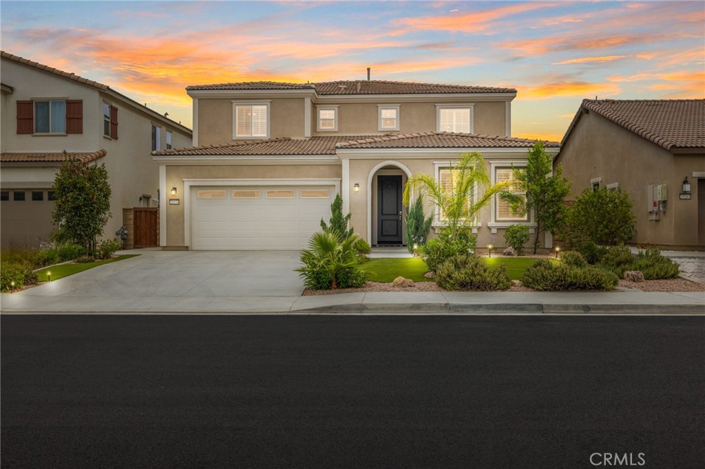 Rarely available LAKE VIEW home featuring one of the most desirable open floor plans with over $100,000 in high end finishes located in the highly desirable Heritage Lake community in Menifee. This two-story home sits on a quiet cul-de-sac and features 4 bedrooms, 3 full baths, PAID OFF solar, and smart home controls. The front yard greets you with an extended-width driveway for ample parking and excellent curb appeal with mountain views. Inside, enjoy a bright and open floor plan with neutral tones, LVP flooring, custom paint, and plantation shutters throughout. Advanced Wi-Fi repeaters ensure strong connectivity across both levels. The chef’s kitchen is a showstopper, offering dark granite counters, an eat-up island, a large walk-in pantry, white cabinets with built-in pot and pan drawers, upgraded stainless steel appliances, including double ovens, a premium counter depth, double freezer LG fridge, DELFINO glass flicker white mosaic tile backsplash with custom chandeliers and pendant lighting. The spacious great room includes a built-in Bose surround sound system, and 77''LG OLED TV and sound bar ideal for both relaxing and entertaining. The versatile dining space can be used as a thoughtfully designed flex space. The main floor also features a spacious downstairs bedroom and full bath with a walk-in shower. The 2.5 car garage has "Cloud" color flooring with a clear epoxy topcoat. Heading up the LVP floored stairs you are dropped off into a large loft on the second story featuring an oversized laundry room including premium LG washer and dryer and tons of storage. The two spacious secondary bedrooms boast carpet, ceiling fans and tons of natural light. The private primary suite features LVP flooring, plantation shutters, and a spa-like ensuite bath with a dual vanity, and a walk-in closet professionally designed by California Closets with 25 soft-close drawers. The entertainers dream yard offers drought-tolerant landscaping with artificial turf, a CA room with privacy shade and a ceiling fan, and a private above ground spa. Enjoy all that Heritage Lake has to offer: a Jr. Olympic-sized pool, 25-acre lake with paddle boats, splash park, catch-and-release fishing, fitness trail, sports courts, community parks and club house. Conveniently located near Temecula Wine Country, I-215, and the new McCall Shopping Plaza. The home is part of Menifee school district with Romoland school zoning for Mesa View ES, Ethan A Chase MS and Heritage HS.