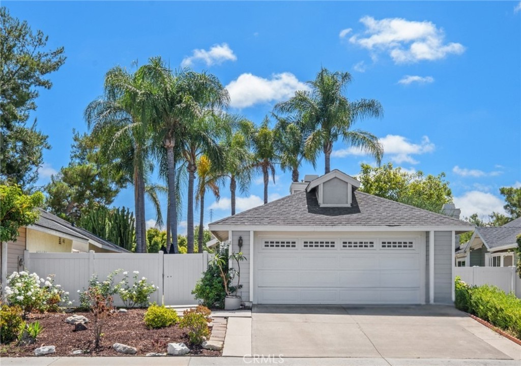 Welcome to 51 Oxbow Creek Lane, a rare single-level retreat in the sought-after Woodwinds enclave of Laguna Hills. This detached 2-bedroom, 2-bathroom home spans approximately 1,090 square feet of thoughtfully curated interiors, set upon a 4,500-square-foot lot with an attached two-car garage. A gated courtyard framed by lush greenery sets a warm, private tone before stepping inside, where open and sunlit spaces blend an airy family room and dining area with the ease of direct garage access and an indoor laundry room. Recently installed vinyl flooring introduces a modern, streamlined sensibility, while plush carpet in the bedrooms adds comfort and warmth. The primary suite is both functional and inviting, with dual closets and an en-suite bath featuring double sinks. The Woodwinds community is beloved for its tree-lined streets, low HOA fees, and prime location—just moments from Sheep Hills Park, the Laguna Hills Community Center, and the scenic Aliso Creek Trail, ideal for morning outings, weekend strolls, or simply savoring the outdoors. A short drive leads to The Village at Nellie Gail Ranch, the reimagined Laguna Hills Mall district, and Aliso Viejo Town Center, offering shopping, dining, and wellness destinations. This single-level layout, designed without interior steps, holds broad appeal for first-time buyers, investors, or those seeking to downsize without compromise, while the private backyard invites alfresco dining, quiet gatherings, or personalized landscape design. Positioned near top-rated schools, major freeways (73, 5, and 405), and just minutes from the coast, 51 Oxbow Creek Lane is more than an address—it’s an opportunity to bring your vision to life in one of South Orange County’s most central and desirable communities.