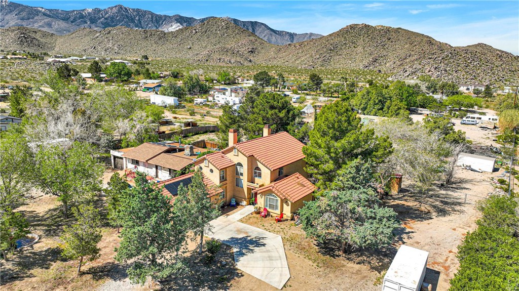 Incredible two-story home located in a highly sought-after area of Lucerne Valley! This property boast with TWO dwellings, a fully fenced yard, and a lot of recent upgrades! The primary home is a 2 story custom build with 2 large bedrooms, 2 bathrooms, 2 office areas, AND a bonus patio room! As you enter the home you’re welcomed by a grand living with cathedral ceilings, and an exceptional amount of space. To the left of the entry you are welcomed by an oversized kitchen, along with a formal dining room and an enclosed breezeway that leads to the additional dwelling. On the R wing of the home you have a great size bedroom and full bathroom with a custom barn darn to create ample privacy! As you go up the grand staircase you have ample natural lighting! On the second floor you have two large office spaces with custom built ins! The large master bedroom offers a tremendous amount of space with a large en-suite bathroom with a soaking tub, walk in shower, fireplace and dual vanities! If that wasn’t enough you also have a bonus enclosed patio room off the master bedroom that could be converted to an additional bedroom, gym, sunroom or more! The secondary dwelling has exceptional potential! It boast with 2 bedrooms a full size bathroom, galley kitchen and large living space area! The dwelling is in need of TLC but the possibilities are endless! If the home didn’t wow you enough, you have a huge lot it’s shy of 1.5 acres with mature trees, sturdy fence and ample space to grow! Seller is MOTIVATED, and has priced to sell!