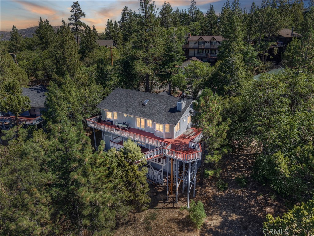 FOUR BEDROOMS WITH SPECTACULAR VIEWS! Wait until you see the LAKE and both Ski Slope Views from this woodsy four bedroom, two bath plus a family room, including two fireplaces, an open floor plan with large kitchen island, a large dinning area, woodsy tongue and groove "western" cedar interior, a full laundry room, central forced air heating, two skylights, a central vacuum system and extensive decking to take in the incredible views from Sugarloaf Mountain to the Artic Circle.