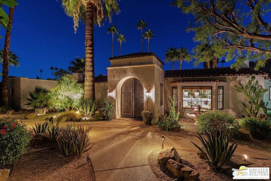 A magnificent remodel of a Spanish Revival home in the heart of Old Las Palmas. Purchased a few years ago, the current owners upgraded the home by keeping the integrity of the 1939 Spanish design while bringing in an elegant modern look throughout.  Arrive through the entry tower into a living room with high beam ceilings, authentic revival fireplace, and views of the backyard and pool.  On the east side, two bedroom suites include a sanctuary like primary with high ceilings, large walk-in closet, and a refreshed bath with double sinks, floating vanity, and large shower. The second bedroom features a full bath and garden views. The west side includes another primary which is attached to a guest suite with sitting area, mini bar, and pool access ideal as an attached casita.  The updated kitchen offers Sub-Zero, Wolf, and Bosch appliances, ample storage, island and a built-in wine and coffee bar which attaches to an elegant dining room surrounded by pool and yard views.  Outdoors, a south-facing saltwater pool and spa, firepit, outdoor shower, and covered cantina with fireplace provide space for entertaining with panoramic wireless mountain views. Desert landscaping, privacy fencing, and gated driveway complete this quiet corner property, an exceptional opportunity in Palm Springs' most desirable neighborhood.
