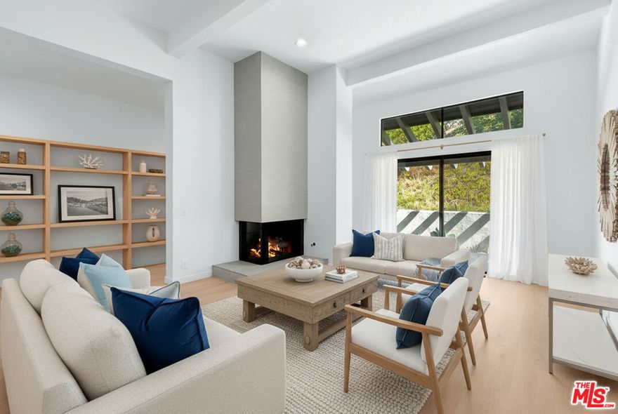 Welcome home to this beautifully remodeled 3-bed, 3-bath home in the Palisades Highlands' coveted Michael Lane Villas. Updated after the fires, it features new hardwood floors, remodeled bathrooms, repurposed kitchen cabinets, a spacious farm sink, and brand-new countertops and appliances. Subtle gold accents add warmth and sophistication, while extra-tall ceilings create an airy sense. A den off the kitchen offers the perfect family or media space, and the living room features a retiled fireplace and stunning wet bar. The primary suite boasts a spa-like ensuite bath with double vanity and floating tub. The secondary bedroom, also with an ensuite bath, enjoys beautiful mountain views. Out front, patterned tiles add charm and character to a patio made for everyday moments. Residents also enjoy a refreshed HOA with pool, gym, and spa. The Highlands is thriving once again.