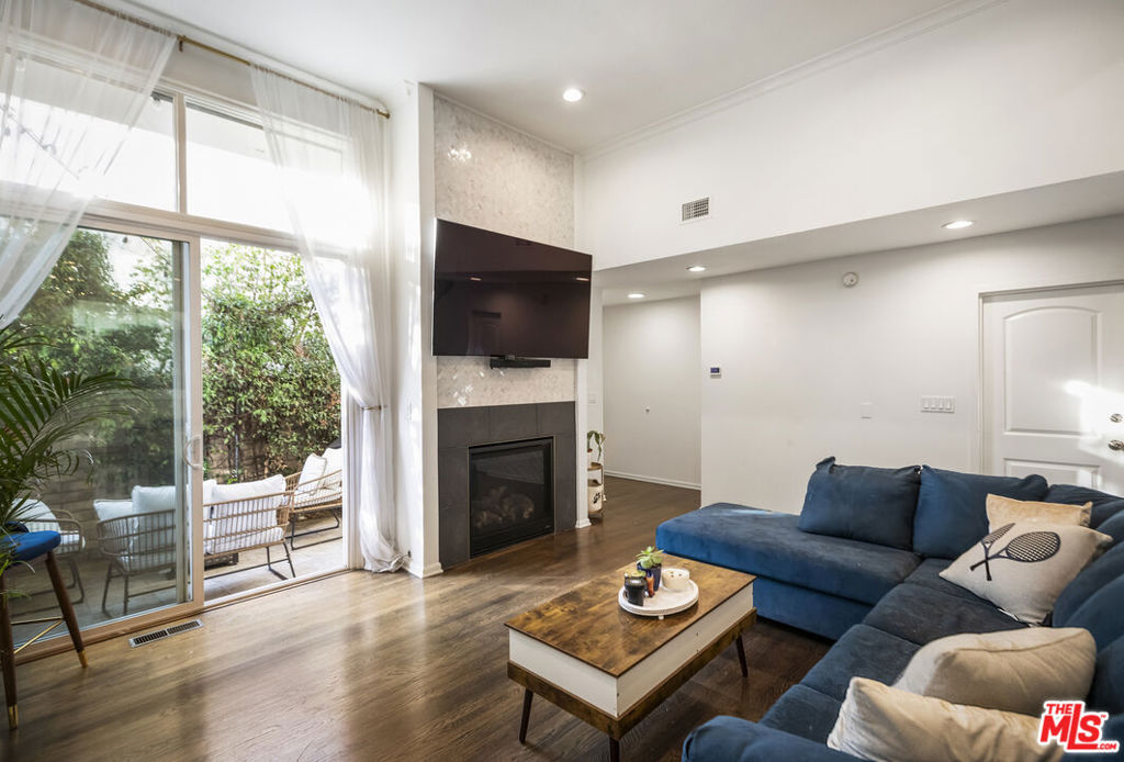 Tucked behind the gates of a charming community, this stylish 2-bedroom, 3-bathroom furnished townhouse is just minutes from great shops and restaurants. Step inside to soaring ceilings, a sleek fireplace, and a sunlit living room that flows effortlessly onto a private patio perfect for relaxing or entertaining. Glass panels separate the dining area while keeping things open and airy. The kitchen is a dream, featuring a large peninsula, a built-in fridge, a dishwasher, and tons of storage in chic, neutral tones. A modern powder room with space for a side-by-side washer and dryer rounds out the main floor. Upstairs, the vibe continues with a spacious primary suite, custom shelving, a private balcony, and a designer-worthy ensuite. The second bedroom boasts wrap-around closets and another stylish ensuite. With an attached garage, extra storage, and central heat and air, this home is the perfect mix of comfort and style. Don't miss it! Can also be rented furnished or unfurnished!!