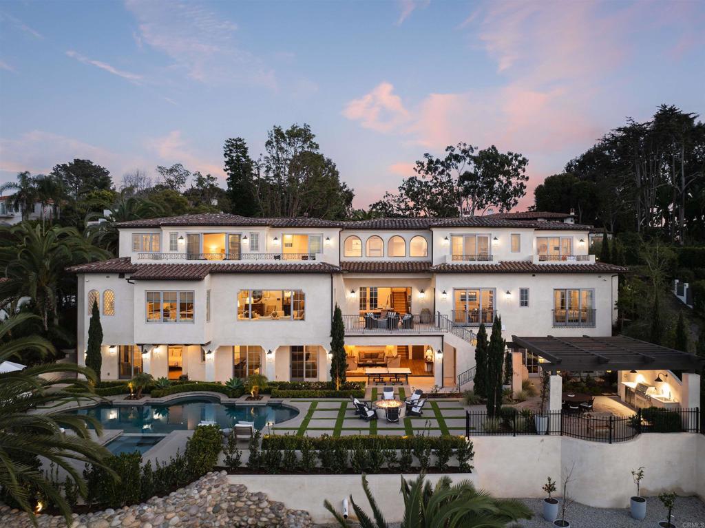 Welcome to an exquisite Muirlands estate, a masterpiece of modern elegance nestled in the heart of La Jolla. This stunning residence offers an unparalleled lifestyle with panoramic ocean, village, and golf course views from all three meticulously designed levels. Step into the main level, where crystal blue ocean vistas greet you from nearly every room. The sophisticated foyer leads to a spacious living area, a gourmet kitchen complete with an adjoining catering kitchen, a formal dining room, and an executive office. This level also features three of the seven luxurious en-suite bedrooms, each thoughtfully designed for comfort and style. Ascend to the second floor to discover the opulent primary suite, a true sanctuary including its private balcony to soak in the panoramic sunsets. Separate wing has two additional ocean view bedrooms. For guests, a private casita is discreetly situated beside the shimmering saltwater pool, offering privacy and tranquility. Embrace a resort-like lifestyle on the lower level, boasting a state-of-the-art wellness center with dry and steam saunas, and a media room with a bar, and a wine cellar. All rooms effortlessly extend to the outdoor oasis, featuring a saltwater pool and spa, a cozy fire pit, and a fully-equipped outdoor kitchen—perfect for entertaining and relaxation. This sophisticated estate is equipped with modern conveniences, including an elevator, advanced Control4 technology, and two laundry rooms. The property also offers a three-car garage and a gated motor court, ensuring ample parking and security. Built in 2021 and meticulously upgraded and maintained, this turn-key residence is a rare gem in the Muirlands, the oldest and most prestigious neighborhoods in La Jolla. Homes in this area seldom come to market, especially those with such spectacular views. Experience the epitome of luxury living in La Jolla, where every detail has been crafted to perfection.