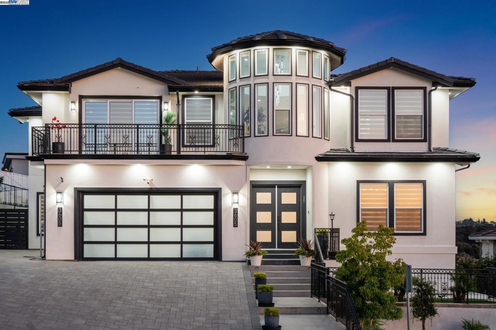 Stunning custom-built home in an exclusive gated community in the Fairview District with breathtaking Bay and SF skyline views. This 4-bedroom, 4-bathroom residence offers luxurious living with all ensuite bedrooms featuring walk-in closets. Step through the grand double doors into a soaring entry with a circular glass staircase and a custom chandelier. The open-concept layout features rich hardwood floors throughout, two full kitchens, including a prep kitchen, and two laundry rooms one on each level for added convenience. The main kitchen features premium appliances, quartz countertops, and modern finishes. Multiple view decks and large windows showcase panoramic vistas. The primary suite offers a spa-like bath with a soaking tub, walk-in shower, dual vanity, and custom tilework. Additional highlights include a paid-off solar system, EV charger, whole-house ventilation system, and beautifully landscaped outdoor spaces. A rare opportunity to own a showstopping home with privacy, functionality, and views in the Bay Area.