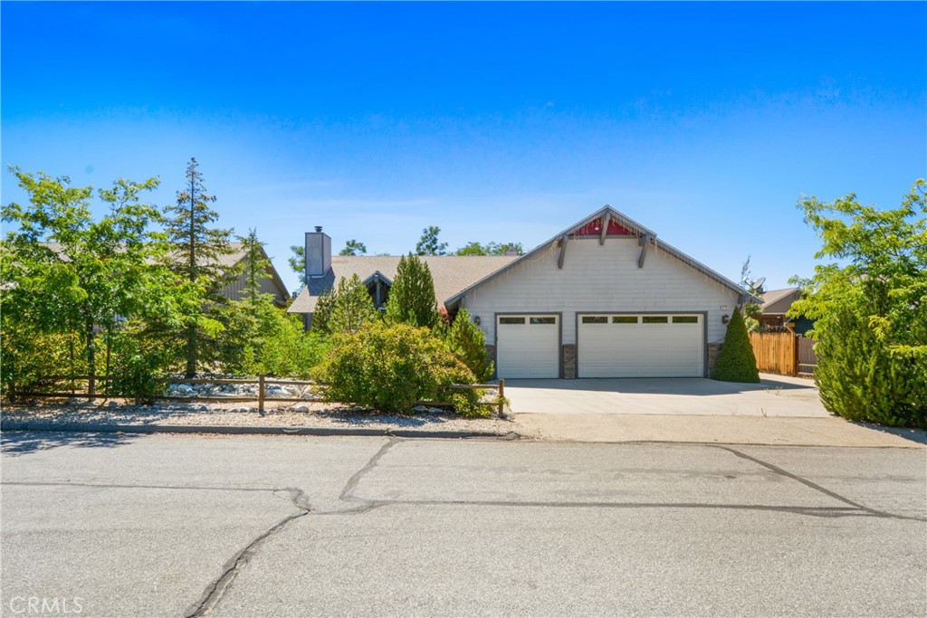 Charming Maple Ridge Retreat. Located in the highly desirable Maple Ridge neighborhood, this beautifully maintained home blends comfort, style, and thoughtful design throughout. From the moment you arrive, you’ll appreciate the pride of ownership and attention to detail that make this property truly special. Step inside to a spacious and light-filled great room featuring soaring vaulted ceilings and a striking floor-to-ceiling stone fireplace. The open-concept layout flows seamlessly into the kitchen, where you'll find granite countertops, abundant cabinetry, and a casual breakfast bar perfect for everyday living and entertaining. The kitchen opens to a cozy family room with a fireplace, creating an inviting space for gathering. Expansive windows throughout the home bring in natural light and enhance the bright, airy feel. Generously sized bedrooms and a dedicated office—ideal for remote work or creative pursuits. The Primary bedroom has a cozy fireplace and its bathroom is large with a walk in closet and separate water closet. A separate laundry room adds everyday convenience. Professionally chosen neutral-toned paint, flooring and fixtures, makes it move-in ready and easy to personalize. Outside, the fully fenced backyard is a private oasis, complete with a large deck, charming gazebo, mature trees, stone accents, and lush landscaping is an ideal setting for enjoying warm summer evenings or peaceful mornings. Set on an approximately 10,000-square-foot lot, the property also includes a direct access oversized three-car garage. Whether you're looking for a full-time residence or a mountain escape, this home is ready to enjoy from day one! Conveniently located near schools, parks, and just minutes from all that Big Bear has to offer, this is a rare opportunity to own in one of the area’s most sought-after neighborhoods. Welcome to Pine Lane where your future home or weekend retreat awaits.