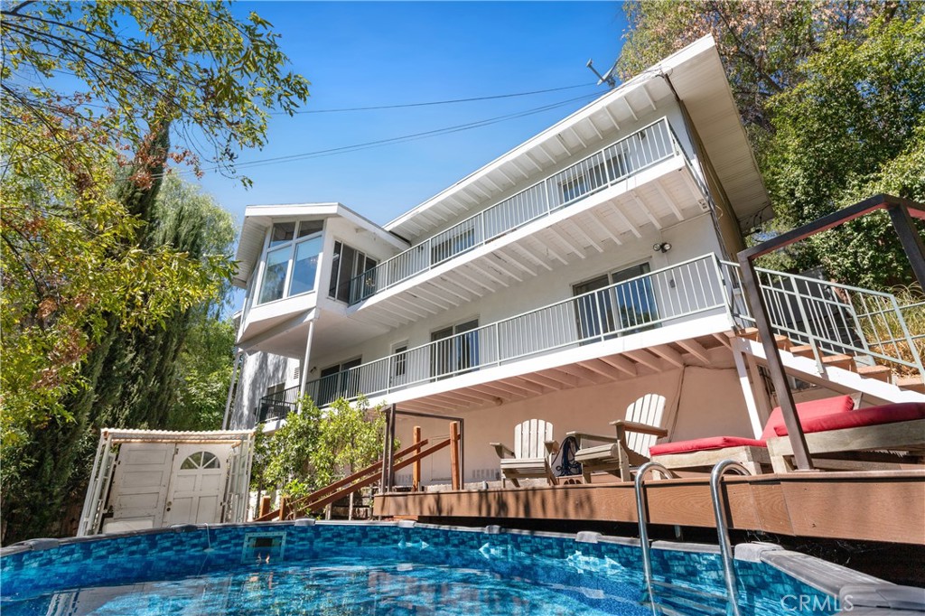 Stunning Mid-Century Gem in Woodland Hills — South of the Boulevard
Step into serenity in this gated hillside retreat, perfectly nestled in the lush, peaceful community of Woodland Hills. Surrounded by trees this South of the Boulevard 5 bedroom, 3 bathroom mid-century modern home offers the ideal blend of nature, privacy, and luxury. Behind double stained-glass doors, you'll find soaring beamed ceilings, skylights, white oak floors, and a spacious open-concept layout. The chef’s kitchen is outfitted with a Miele refrigerator, Viking stove, designer backsplash, new countertops, and a large island ideal for entertaining. Each bedroom opens to its own deck with sweeping hillside views, while the backyard features an above-ground pool, multiple lounge areas, and gated parking. Recent upgrades include a brand-new HVAC system, new water heater, fully paid solar panels, and water softener. Minutes from Trader Joe’s, Whole Foods, The Village, and the Woodland Hills Country Club.