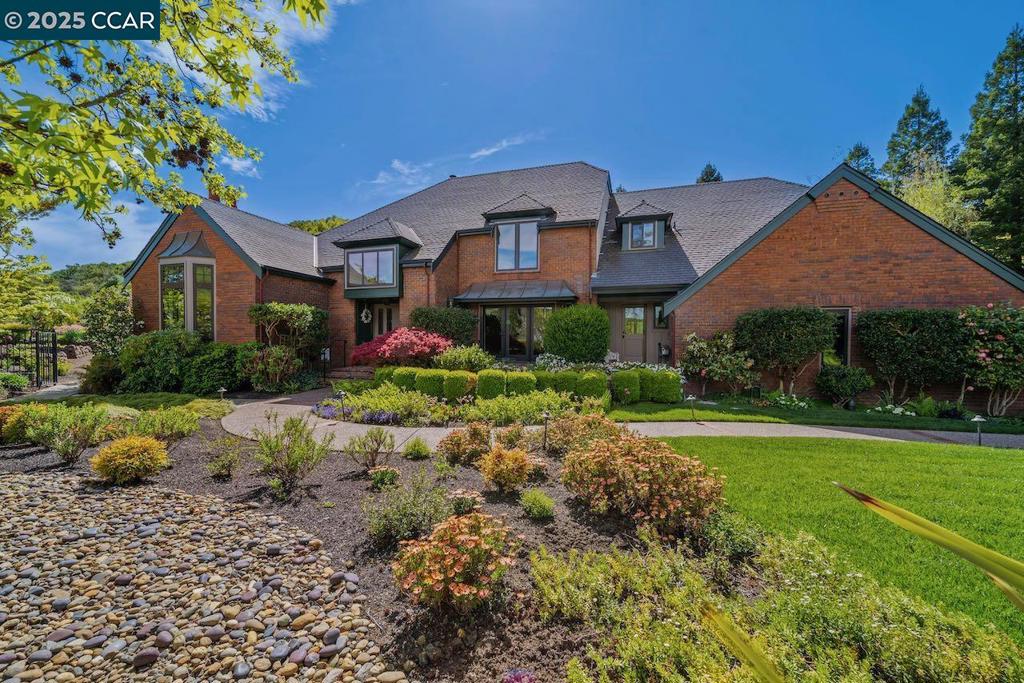 New Price! One of Moraga’s premier estates, this 4,791± sq. ft. Branagh-built residence blends timeless architectural charm with luxurious modern updates. Privately set on a .67-acre lot surrounded by lush landscaping, mature trees, and rolling hills, the home offers unmatched privacy while remaining close to top-rated schools, parks, and community amenities. Inside, a thoughtfully designed floor plan features four spacious bedrooms plus a den and 4.5 bathrooms. The grand entry leads to sunlit living spaces with soaring ceilings, custom millwork, and oversized windows framing serene garden views. Multiple gathering areas — from the formal living room to the inviting family room — create a seamless flow for entertaining and everyday living. The gourmet kitchen boasts high-end appliances, expansive countertops, and ample storage, w/ a breakfast nook & formal dining room ideal for hosting. The luxurious primary suite offers spa-like amenities, tranquil views, and direct access to landscaped grounds. The resort-style living awaits with a sparkling pool and spa, stone patios, curated gardens, and secluded seating areas — all set against sweeping views of Moraga’s hillsides. Located in gated Sanders Ranch, this estate perfectly balances natural beauty, privacy, and lifestyle.