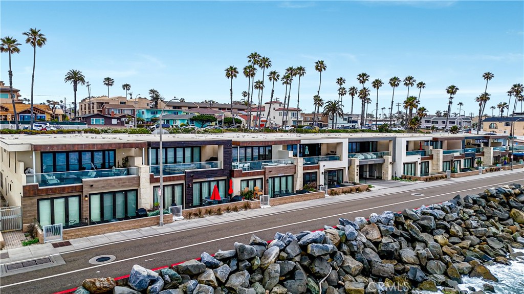 Discover exquisite design and thoughtful luxury in this 2,327 sq ft oceanfront condo, built in 2017 and offered fully furnished. This second-floor residence features 3 bedrooms, all en suite, plus a powder room, ensuring ultimate comfort and privacy. Upon entry, a 230 sq ft interior courtyard provides a serene transitional space. The main living area boasts a gourmet kitchen with a stone slab island and top-tier stainless appliances, which opens to the dining and living spaces. This great room seamlessly connects to a 220 sq ft covered balcony via a wall of glass doors. The primary suite is a luxurious retreat with a large, appointed dressing room and a spa-style bath featuring dual sinks and an oversized shower. The private, detached third bedroom casita, located off the courtyard, includes a coffee/juice bar creating the perfect guest retreat. Practical features include a full-size laundry room with abundant storage, 2 parking spaces and a storage room in the secure gated garage, and elevator access. Every day feels like a vacation, from waking up in the luxurious primary suite to the sounds of the surf, to enjoying a morning run on the sand, to strolling to Oceanside’s trendy new restaurants and resorts. With the building allowing short-term rentals, this property is great for investment and also as a turnkey beachfront getaway.