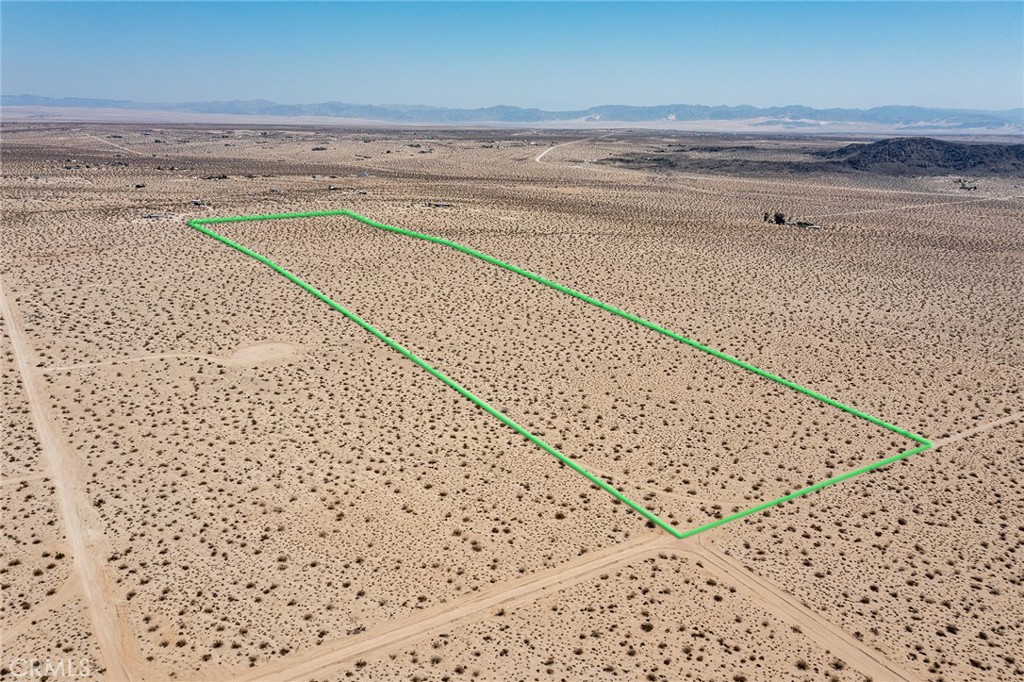 Nearly 40-MASSIVE ACRES of Rural, Sublime Desert, surrounded by wilderness. Northern edge of parcel borders La Brisa for easy acess to paved Sunfair Rd to the east and paved Border Ave to the west. Southern side of parcel borders Sunny Sands Dr. Huge parcel to split into smaller lots or develop as one large lot. Water and electricity on La Brisa (buyer to check). Views of the ridgelines in Joshua Tree National Park to the south. NOTE: Green lines demarcating boundaries in pictures are approximate, as property has not been surveyed; street address is not official – do not use address or google maps GPS to locate property. To find property, please locate with APN: 0606-321-12