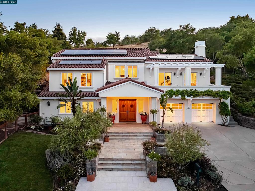 This Mediterranean-style home sits on a quiet street, well removed from traffic, halfway between downtown Orinda and Miramonte High. Enter past a manicured garden. A short flight of stairs, in distinctive Brazilian cherry, invites one upward to the main floor. Large windows draw in cheery morning sun. The living/family room covers 520 square feet under a coffered ceiling, with a wet bar and counter, wine cellar, oversized fireplace, and deck access. The living room flows seamlessly to the dining room. The kitchen, also under an elevated ceiling, offers Sub-Zero and other elite appliances, granite counters and an island, a breakfast bar seating 4, a comfortable sitting area alongside, and access to the side deck and outdoor kitchen. Three of the 4 bedrooms, all with en-suite baths, lie on the home’s top floor. The spacious primary suite is particularly distinctive, with views on 3 sides, a coffered ceiling, and an oversized fireplace. Two bedrooms complete the floor, with the laundry room conveniently between. The floor also offers access to the garden and covered deck. The 4th bedroom and full bath, ideal for guests, sits apart from the others, on the first floor. Nearby Moraga Road provides easy access to the 24 freeway, BART, downtown Orinda, and local schools.