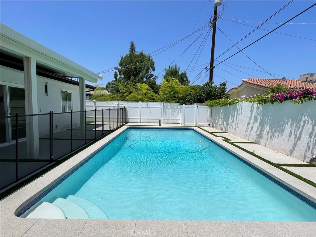 Welcome to this beautifully remodeled and fully gated compound in the heart of Tarzana. The main house at 18823 Martha St leases for $4,999/month and features 3 bedrooms, 2 bathrooms, an open layout with wide-plank floors, recessed lighting, and a chef’s kitchen with high-end appliances, custom cabinetry, and two large islands. The primary suite includes a walk-in closet and upgraded ensuite bath. The backyard offers a sparkling pool, lush landscaping, and space to entertain. The separate ADU has already been leased out. Additional features include central HVAC, washer/dryer, smart locks, a full security system, gated parking, and included landscaping and pool service. Prime location near Ventura Blvd, shops, dining, and freeways.