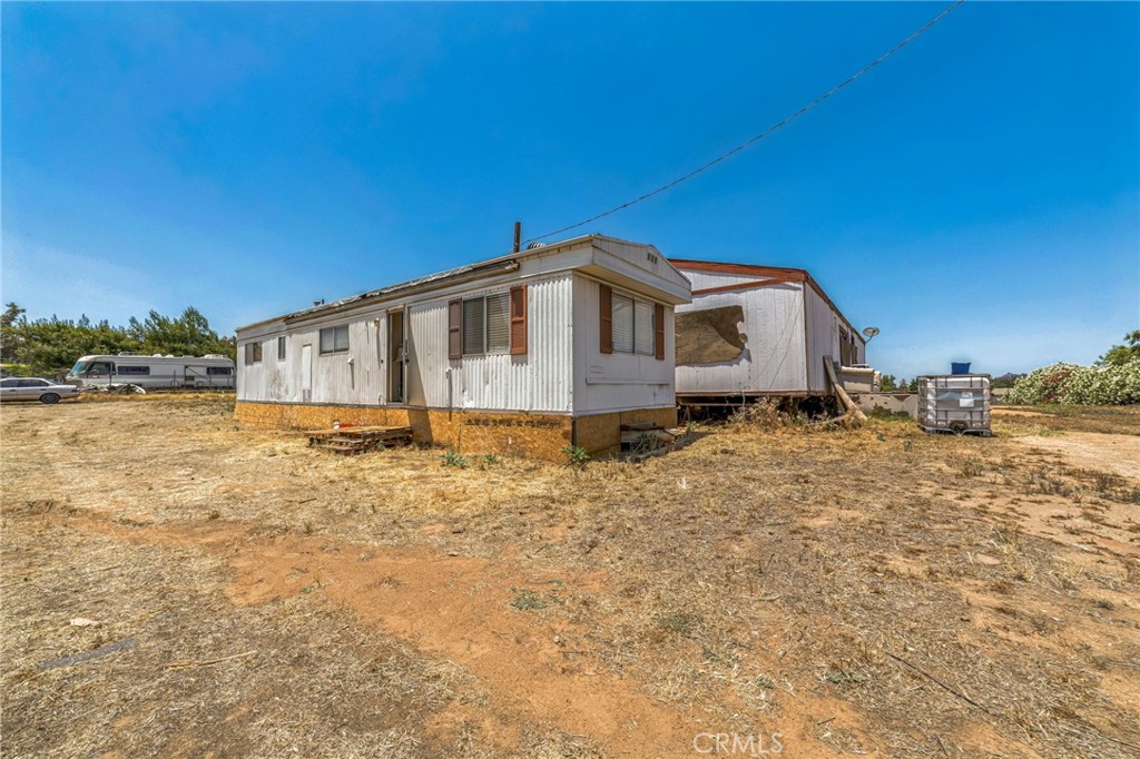 Rare 2-home setup on large 1.7+ acre flat lot in Perris! CASH-ONLY. Two manufactured homes with separate access perfect for multi-gen living or investor looking for land and upside. Front unit approx. 1,150 sq ft, 3/2. Rear unit is older and needs TLC. Great bones, flat land, RV/trailer access, zoned for rural/agricultural use. Septic and shared utilities. Sold as-is. One or both homes may not be on permanent foundation buyer to verify all permits, square footage, and foundation type. Property will be delivered vacant. Serious cash buyers only.