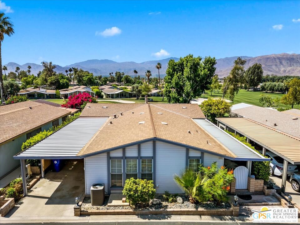 Welcome to 73450 Country Club Drive #295, a stunning triple-wide manufactured home nestled in the highly sought-after 55+ gated community of Suncrest in Palm Desert. Perfectly positioned on the golf course, this home offers million-dollar panoramic views of the fairways and majestic mountains through floor-to-ceiling windows that bring in natural light and beauty throughout the day. Inside, you'll find 3 spacious bedrooms and 2 full baths, including a luxurious primary suite with a jetted soaking tub, dual walk-in closets, and ample space for relaxation. The gas fireplace anchors the living room, creating a warm and inviting ambiance, while the high ceilings and beautiful laminate flooring throughout elevate the home's elegance. The large dining room is perfect for entertaining, all while enjoying the stunning golf course scenery. Enjoy the convenience of a separate laundry room with generous storage, a 2-car carport, and an additional shed for your tools or hobbies. Step outside to a private patio perched along the golf course, an ideal setting for morning coffee or evening sunsets and libations. Located in a rent-controlled community, Suncrest offers incredible resort-style amenities including a 9-hole golf course, 3 pools and spas, tennis and pickleball courts, a clubhouse with cafe, billiards room, and library. The community frequently hosts fun parties and events. This is more than just a home it's a lifestyle.