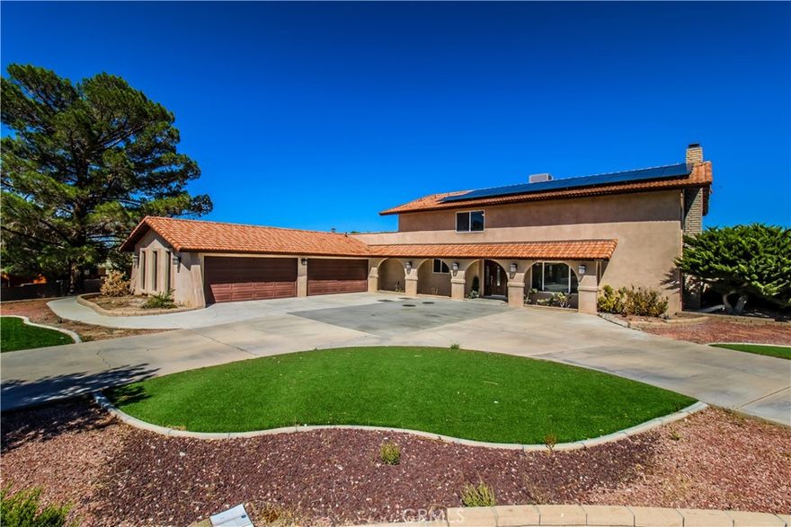 Size and space in Apple Valley! Situated on nearly an acre in one of the town’s most desirable neighborhoods, this 4 bed, 4 bath home offers 2,572 sq ft of living space, two en suite bedrooms (one up, one down), and each additional bedroom with its own bath access. Step inside to soaring ceilings, a dramatic staircase, elegant wood-look floors, and a chef’s kitchen with granite counters and rich cabinetry. Outside, enjoy a covered patio and your very own backyard putting green—perfect for entertaining on warm desert evenings. Energy-efficient solar, a 4-car garage, and a large circular drive add to the appeal. Sq. Ft. not verified. Information deemed reliable, not guaranteed.