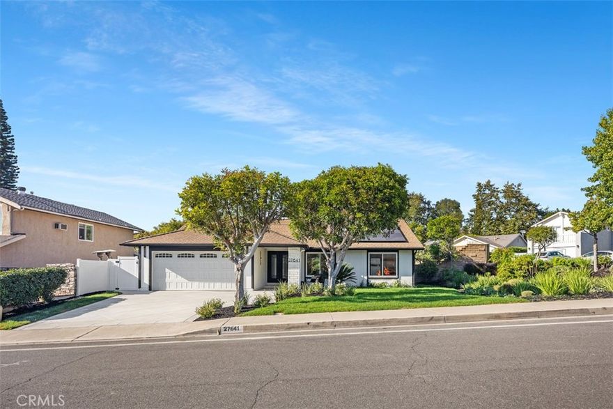 A stunning single-level retreat where modern design meets everyday comfort in Mission Viejo’s sought-after New Castille community. This fully renovated 3-bedroom, 2-bath residence offers 1,546 sq ft of beautifully reimagined living space on a large lot. The heart of the home is a true chef’s kitchen, crafted for both form and function, with custom cabinetry, floating white oak shelves, sleek quartz counters, a massive center island, stainless appliances, and an impressive 8-burner professional range with double oven. Open-concept living spaces flow effortlessly, featuring wide-plank wood floors, designer lighting, and sliding glass doors that open to an expansive patio – an entertainer’s dream for outdoor dining, gatherings, and relaxation. Both bathrooms showcase elegant tilework, frameless glass showers, and high-end finishes that exude spa-like sophistication. The exterior is equally impressive with a freshly painted façade, newly poured driveway, manicured landscaping, and a reimagined backyard framed by a rebuilt retaining wall and lush greenery. Solar panels (leased) and a finished garage with epoxy flooring adds the final touch. Ideally located near Lake Mission Viejo, parks, shopping, and top-rated schools, this home delivers refined style, modern comfort, and effortless California living at its best.