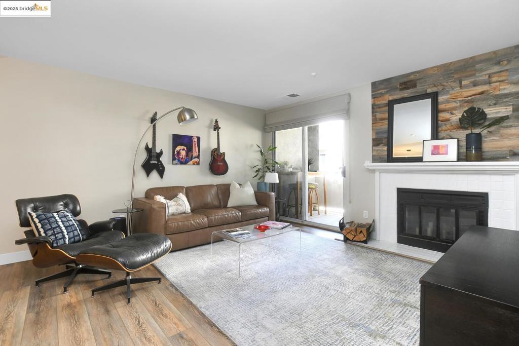 Welcome to this FULLY REMODELED 1 bed, 1 bath condo. Owner is a professional Interior Designer. This well-appointed condo has beautiful, updated designer finishes throughout. Upgrades include; all new lighting fixtures, LVP wood like flooring, upgraded baseboards and trim, Silestone quartz countertops, modern backsplash, reclaimed wood accent fireplace, custom designer blackout shades, newer counter depth refrigerator, and newly installed water heater. Bathroom has also been updated with new vanity, countertop and toilet. This unit has ample storage with large closets in main bedroom and utility closet in hall. The well-maintained complex has a gated entry, parking garage, workout area, and pristine pool/hot tub and clubhouse with entertaining patio. Walk across street to Iron horse walking trail, or Bart to commute. Just 5 minutes to downtown Walnut Creek, for shopping, excellent dining, and many other services. Don't miss this one, it will go fast!