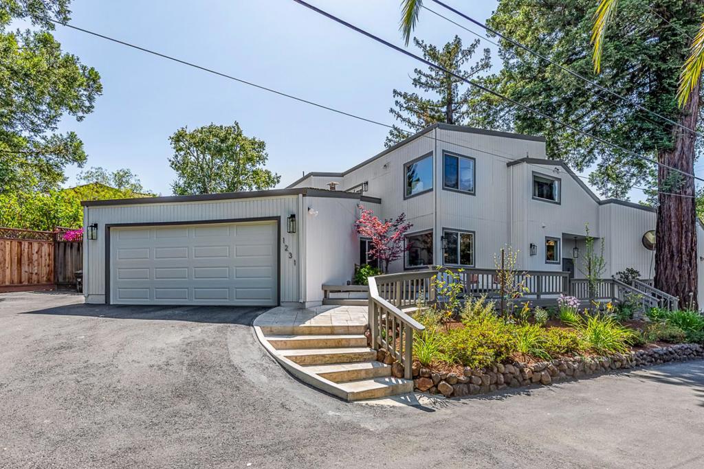 Located at the end of a private lane, this sprawling home is flooded with natural light and features very spacious public rooms, rich wood accents, soaring ceilings, and expansive windows. The dramatic living room sits beneath two-story ceilings highlighted by natural wood paneling and beams, and has a statement fireplace, bar, and aquarium. The kitchen offers abundant storage, granite countertops, and a sunny casual dining area. The family room is the perfect place to gather with a built-in wet bar and outdoor access. A bedroom suite, or ideal au pair quarters, sits on one side of the home, and two additional main-level bedrooms have easy access to a full bath. The primary suite is privately situated on the upper level with a lovely terrace, generous walk-in closet, en suite bath with a deep jacuzzi tub, and an adjacent office with substantial built-ins. Outside, the professionally landscaped lot features a resort-style pool and spa, a covered dining patio, vast decking, gorgeous mature trees, and a large storage shed. All of this, with Rancho Shopping Center, commute routes, and downtown amenities just moments away!