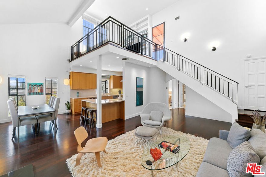 Experience refined living in this rare two-story penthouse at 412 Arnaz Dr. Positioned on the top floor, south-facing corner, this light-filled residence offers dramatic soaring ceilings, expansive feeling open-concept living, and upscale designer finishes  all just moments from Beverly Hills, The Beverly Center, West Hollywood, and world famous Los Angeles restaurants. Step inside to discover a spacious and sophisticated floor plan, ideal for entertaining. The main level features a modern chef's kitchen with limestone countertops, Sub-Zero refrigerator, Viking range, Miele dishwasher, and abundant cabinetry, all flowing seamlessly into the open living and dining areas. Oversized windows capture brilliant southern light and showcase the home's stunning volume and scale. The first floor also includes two generously sized bedrooms and two beautifully updated bathrooms, including a luxurious primary suite with a huge cedar-lined walk-in closet and spa-like bath. The second bathroom features a glass-enclosed oversized tiled shower and a large vanity with sleek finishes. In-unit laundry, custom storage, and warm wood floors complete the level. Upstairs, a stylish loft with built-in shelving overlooks the living room and offers the perfect space for a home office, library, or media lounge. Step outside to your private covered rooftop deck  perfect for outdoor dining, entertaining, or simply relaxing with expansive city views. A rare bonus storage room off the deck adds even more convenience, offering space few condominiums provide.One of the most unique features of this penthouse is the private two-car garage with direct access to the building lobby  an extremely rare amenity in condo living. The garage is equipped with EV charging outlet, offers additional room for storage, and is accessed from the side street.Located in a secure, well-maintained building in one of Los Angeles' most sought-after neighborhoods, this stunning penthouse is Beverly Hills adjacent, close to shopping, fine dining, galleries, and major studios..
