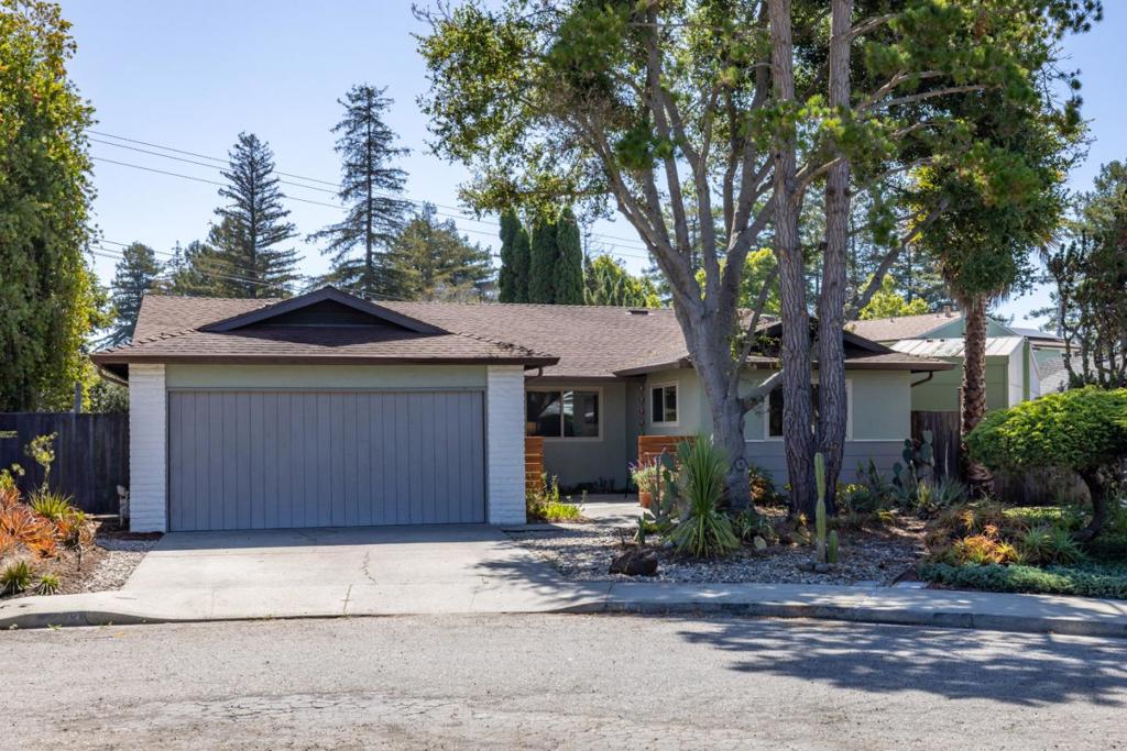 Welcome to 103 Calvin Place! A comfortable, tastefully updated and move in ready 4 bd / 2 ba home on a large lot at the end of a cul-de-sac in University Terrace on the Upper Westside banana belt. Located in close proximity to UCSC, University Terrace Park, Westlake School, shopping, restaurants and beaches. Enter through a front courtyard framed with redwood and see the warm, inviting great room, which features a gas fireplace, adjacent dining area, and striking open beam ceilings. Large windows and a sliding glass door opening to the backyard add abundant natural light. The functional kitchen is ready for your home cooking with white cabinets and Corian counters, 5-burner gas cooktop, double oven, and eat-in area with a sliding glass door to the side yard. You'll find hardwood floors in the living areas and bedrooms, with new flooring in the kitchen and bathrooms. The primary suite has a slider looking out to the backyard. Built-in cabinets, a bonus utility room, two large storage sheds, and a two-car garage offer excellent storage. The nearly 10,000 sqft wraparound lot provides privacy and space to garden, with a large patio, fruit orchard, and distinctive botanical landscaping, plus easy ADU potential. Owned 4.7kW solar system updated in 2021 reduces energy costs.