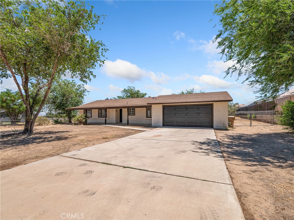 Wonderfully renovated home offer 3 bedrooms and 2 bathrooms on a spacious 31,500 sq foot private lot. This home has been nearly redone from top to bottom with new paint inside and out, and new quality laminate wood flooring in entryway, kitchen, living room, hallway and bathrooms along with new carpet in the bedrooms. The kitchen has been reimagined with painted cabinets and new hardware, as well as new quartz countertops and new stainless steel appliances. The living room has been opened up to the kitchen for more enjoyable family living. The sun room behind the garage is not included in the advertised square footage but provides the perfect blank tablet for someone to add a recreational space, gym space, or craft space with it's own direct access to the garage. The home has a brand new heating and AC unit. This home is centrally located and has both Victorville and Hesperia shopping to its benefit.