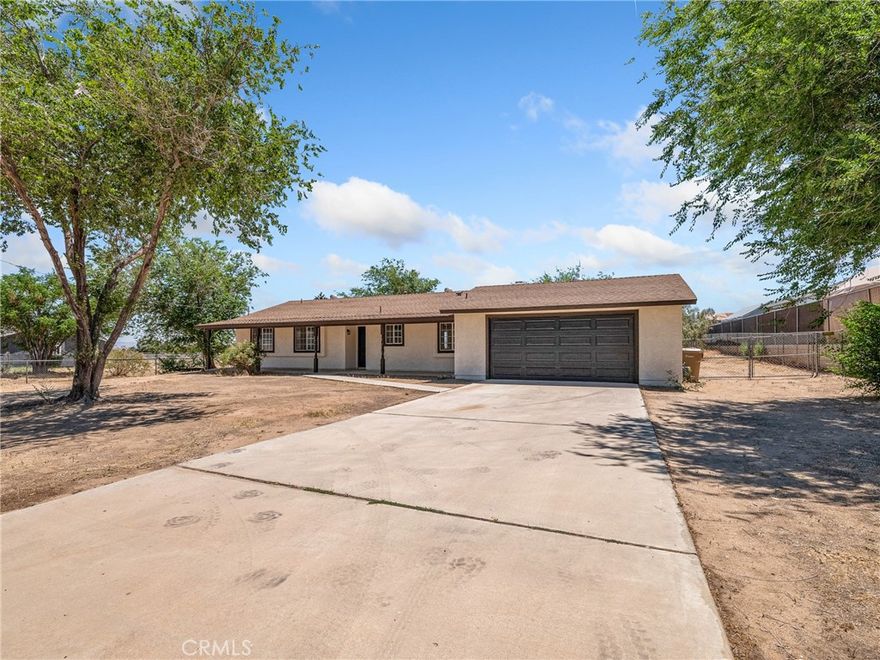 Wonderfully renovated home offer 3 bedrooms and 2 bathrooms on a spacious 31,500 sq foot private lot.  This home has been nearly redone from top to bottom with new paint inside and out, and new quality laminate wood flooring in entryway, kitchen, living room, hallway and bathrooms along with new carpet in the bedrooms.  The kitchen has been reimagined with painted cabinets and new hardware, as well as new quartz countertops and new stainless steel appliances.  The living room has been opened up to the kitchen for more enjoyable family living.  The sun room behind the garage is not included in the advertised square footage but provides the perfect blank tablet for someone to add a recreational space, gym space, or craft space with it's own direct access to the garage.  The home has a brand new heating and AC unit.  This home is centrally located and has both Victorville and Hesperia shopping to its benefit.