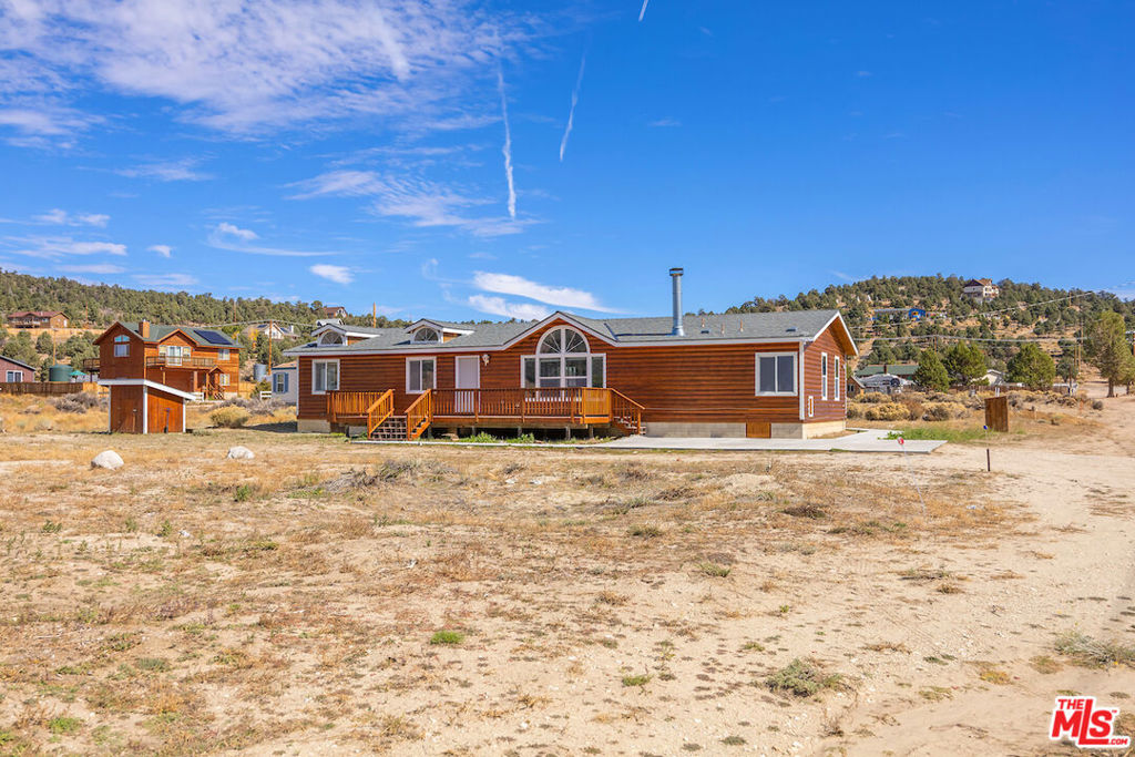 Amazing Views!!! Mountain retreat with spacious 5 bedrooms/2 bathrooms in the Big Bear, Baldwin Lake area. The unit is cash flowing and income producing, currently Tenant occupied. Large deck for outdoor get togethers. The the 5th bedroom is actually a den/office with sliding glass doors leading outside. New roof, new exterior wood stain, new interior paint, new flooring, refinished cabinetry, and a lot more. The living room features a cozy fireplace for those cold winter nights. Washer and dryer inside the unit. The kitchen features an island with butcher block countertops. Plenty of parking available. Short drive to the slopes, lake, shopping, and other amenities. Comes with its own well, no hauling water, a sewer holding tank, propane gas, public electricity. Manufactured home on a permanent foundation. Please do not disturb and speak to the occupants. Photos were taken before the Tenants move-in.