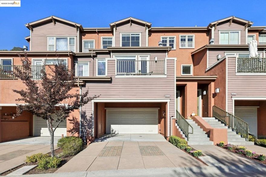 Discover elevated living in this stylish townhome perched in the sought-after Monte Vista Villas community of the Oakland Hills; Impeccably maintained by its original owners - who purchased it new in 2013 and thoughtfully upgraded it with solar power (owned), air conditioning, and much more; The main level showcases an open-concept floor plan with seamless flow to a balcony offering sweeping SF Bay views; A chef’s kitchen with premium finishes opens to a private rear yard - perfect for indoor/outdoor dining and entertaining - while a guest suite with full bath adds flexibility; Upstairs, the primary suite features inspiring views and a spa-like bath; Two additional bedrooms, a full bath, and a laundry room complete the top level; The street level includes an oversized two-car garage with direct interior access; Outdoors, you’ll enjoy serene greenbelt-style grounds with walking paths, a playground, and a fitness center; Located just minutes from Montclair Village’s charming shops and restaurants, with easy access to AC Transit to SF and Highways 580/13/24, this home offers the best of Oakland Hillside living - modern luxury with breathtaking vistas.