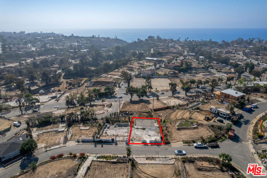 Nestled on a quiet street in the lower Marquez Knolls neighborhood, this exceptional lot presents an opportunity to build your dream home with beautiful ocean views from the first and second stories. Ideally located just minutes from the beach, Palisades Village, and Lake Shrine, this property is also in close proximity to the highly-rated Marquez Elementary School. Although the previous 2,210-square-foot structure was lost in the Palisades Fire, the owners built a flat, picturesque backyard perfect for entertaining with a substantial retaining wall that remains intact. This is one of the few lots in the lower Marquez area that offers a flat backyard along with ocean views, making it the ideal spot to enjoy the Palisades fireworks (or drone shows) on the Fourth of July. Phase 1 and 2 have been completed by the owner and primed for a fresh start with the added benefit of a streamlined fast track rebuilding process.