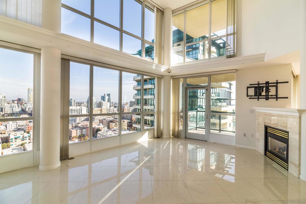 Want to feel like you have a house of your own in the sky? There is no property like it downtown, with over 2500 square feet of comfort and elegance. This 2-story townhome on the 20th and 21st floor features gorgeous porcelain flooring, floor-to-ceiling windows with motorized blinds, an incredibly open floor plan, and FOUR inviting balconies. It also boasts a spacious kitchen with an abundance of cabinet space, as well as three large bedroom suites. Enjoy sweeping views of the Coronado Bay, the Marina, and the easterly mountain views - truly a must see! Side-by-side parking and storage included. Incredible harbor views west, south towards Coronado and Eastern views provide a great, mountainous backdrop for the San Diego's city skyline! Complex features 24 hour security and concierge, beautiful facilities including a pool, recreation, and fitness center, plus guest parking. Located in the heart of the Marina District and possibly the best location of all downtown high-rises! Two side-by-side parking spaces and storage are included. Come see one of the best floor plans downtown!