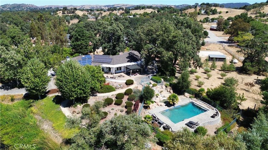 Set within the coveted Chandler Ranch neighborhood in West Atasacadero, this 3.93-acre estate captures the essence of living on the Central Coast. Offering 5 bedrooms and 3.5 baths, the residence was originally crafted in 1983 and has since been tastefully renewed with modern upgrades. The heart of the home is its beautifully remodeled kitchen, featuring marble counters and accent backsplash, custom cabinetry, and seamless flow to an expansive outdoor patio paved in stone, where a fire pit, pergola, and integrated speakers create the perfect atmosphere for gatherings.



The interiors balance sophistication with comfort. A newly finished laundry room combines large slate flooring with abundant storage, while the subterranean wine cellar, lined with cork and built for 280 bottles, adds character and function. Flexible living spaces include a cozy game room with fireplace, a private office with built-in cabinets, and a dedicated fitness room. Upstairs, every bedroom opens to a private balcony or deck, and the primary suite stands apart with dual walk-in closets, spa-inspired bath, heated tile floors, a steam shower, and a deck designed for moonlit views overlooking the private lake.



Outdoor living is elevated by a cascading water feature: the spa gently spills into a shallow kiddie pool before reaching the main pool all surrounded by a secure perimeter fence. Beyond the pool, you’ll enjoy your own private lake stocked with bass and catfish which has been the centerpiece of the property for decades, bordered by mature oaks, fruit and nut trees, and wildlife . With dual solar systems, EV charging, and a fully pavered driveway, this estate delivers both efficiency and timeless appeal. A rare offering in one of Atascadero’s most desirable neighborhoods, 8189 San Dimas Rd presents a lifestyle of beauty, privacy, and distinction.