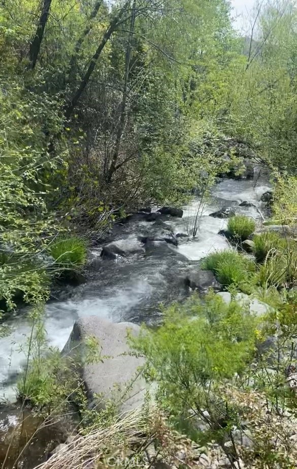Enjoy the sounds and access of year round Putah creek running thru your property! Now has 2 building pads on over 21 acres. Choose your dream home site with electricity at the driveway. Includes building plans for a 2 bed 2 bath house, total of 4 parcels, water tank, graded roads, and valley views overlooking Middletown. Possible opportunity to share the neighbor's well. Only 20 min drive to a hot springs resort, 5 min to a swimming hole, 8 min drive to Middletown. Fire had swept thru this area 10 years ago and new growth has abound.