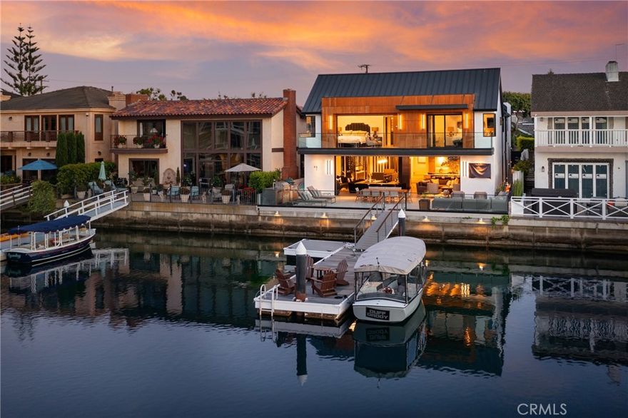 Welcome to one of Newport Beach’s most exceptional waterfront estates — a showpiece of modern coastal design and world-class craftsmanship. Perfectly positioned on prestigious Harbor Island Drive, this architect-driven residence blends sleek contemporary living with resort-style amenities and jaw-dropping panoramic bay views. Walls of La Cantina glass disappear for a true indoor/outdoor experience, opening to an expansive entertainer’s deck complete with Wolf BBQ, Green Egg smoker, beer tap, fire pit, and private 45-foot dock that can accommodate a 55-foot boat. Every inch of this home was built to impress — from the custom lighting and coffered ceilings with wood inlays to the 7” European oak floors and designer finishes throughout. The chef’s kitchen is next-level: La Cornue Flamberge Rotisserie, Wolf 60” dual-fuel range, Sub-Zero refrigeration, Miele dishwasher, Gessi fixtures, and marble prep island. Entertain with style at the step-down bar with custom leather details and Sub-Zero ice maker, or host dinner under statement lighting beside a temperature-controlled wine wall. Upstairs, the primary suite rivals any five-star resort with a vaulted ceiling, fireplace, private balcony, dressing room, steam shower, soaking tub, and Neorest automated toilets. All additional bedrooms are ensuite, offering ultimate comfort and privacy with an additional primary suite on the opposite side of the home. Smart-home automation powered by Crestron controls every element — lighting, climate, music, and security. With panoramic views of Promontory Bay and just minutes from Newport’s best dining and shopping, this is more than a home — it’s a lifestyle statement.