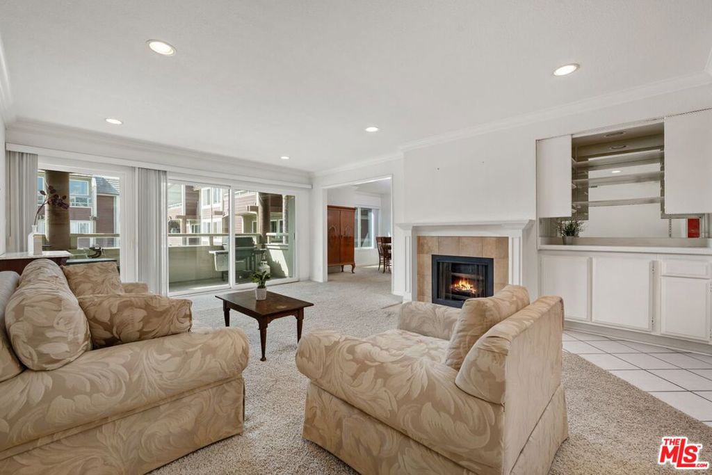 Bright, open and inviting, this nearly 1,600 sq ft single-level corner unit with large south-facing balcony offers a unique opportunity for beach lovers to personalize their dream space in a well-maintained community. Step into a sun-drenched open living area and enjoy cozy evenings by the fireplace, dine in style in the designated dining area, or drink your morning coffee or evening drink on your balcony while overlooking a serene pool area. The kitchen features a center cooking island, abundant cabinetry, and a light-filled breakfast nook. The expansive primary suite is a true retreat, offering a walk-in closet, 2 additional large closets, and a bathroom with a soaking tub and a separate shower. The second bedroom is ideal as a guest room or home office, with direct access to the balcony. Enjoy the convenience of in-unit laundry, recessed lighting, newer double pane windows and sliding doors, two side-by-side parking spaces, an additional storage locker outside the unit, and secure entry with intercom. Located on the exclusive Silver Strand in one of the quietest parts of Marina del Rey, this resort-style community features luxurious amenities such as newly renovated pools and hot tubs, dry saunas, EV chargers, elevators, an updated exterior facade, and ample guest parking. All just moments from the beach, marina, lively restaurants and shops, biking and walking trails, farmer's markets, water taxi, and the Venice Canals.